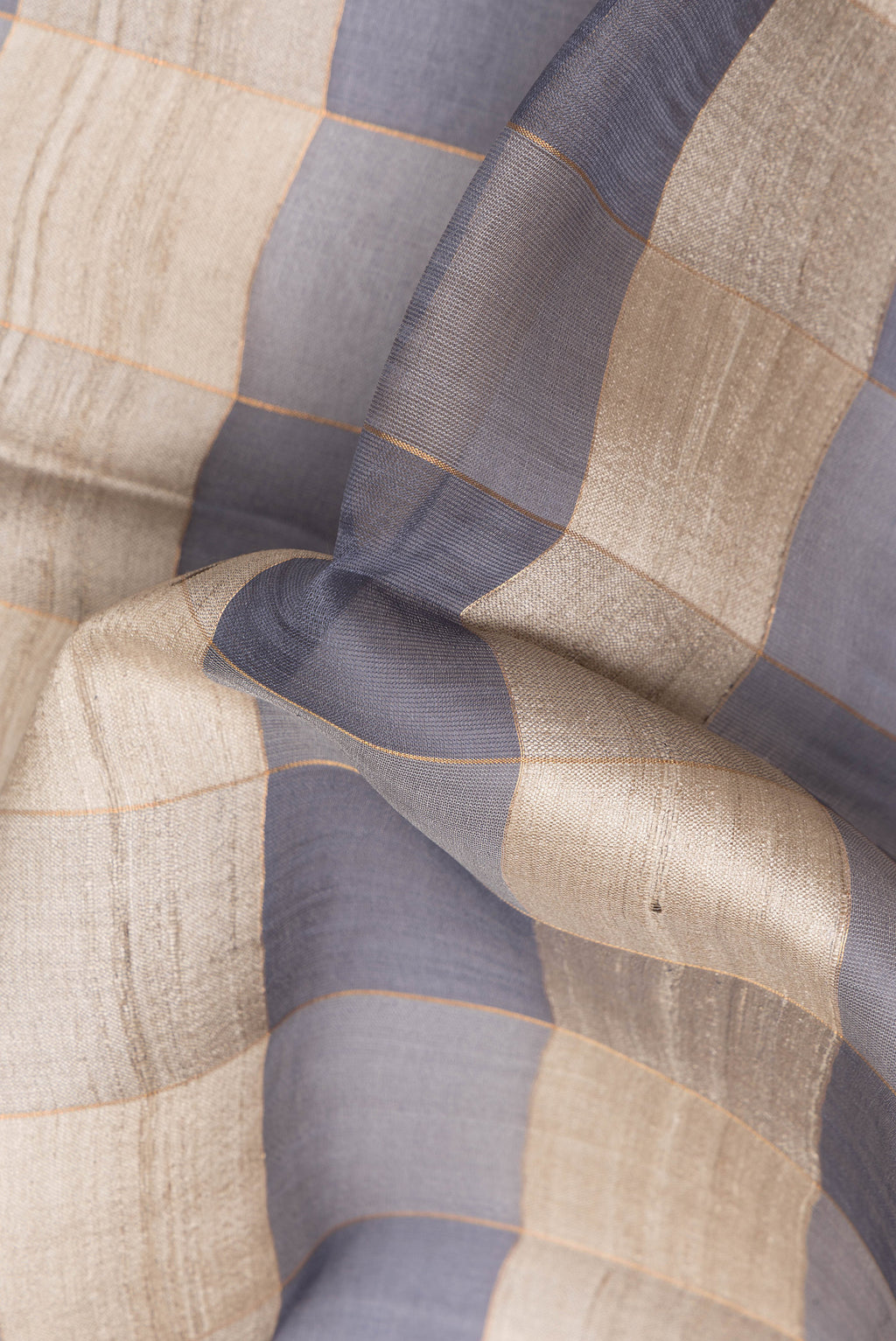 Close up of Multi Color Tussar Saree with Checked design on the body and Zari Border.  displaying folds