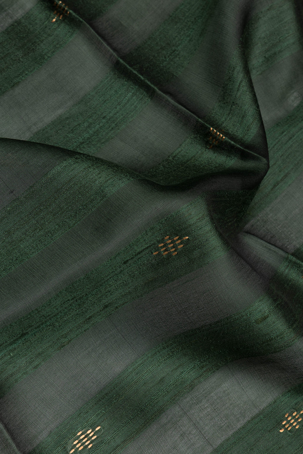 Close up of Olive Green Tussar Silk Saree with Art Illustrations on the body and Zari Border.  displaying folds