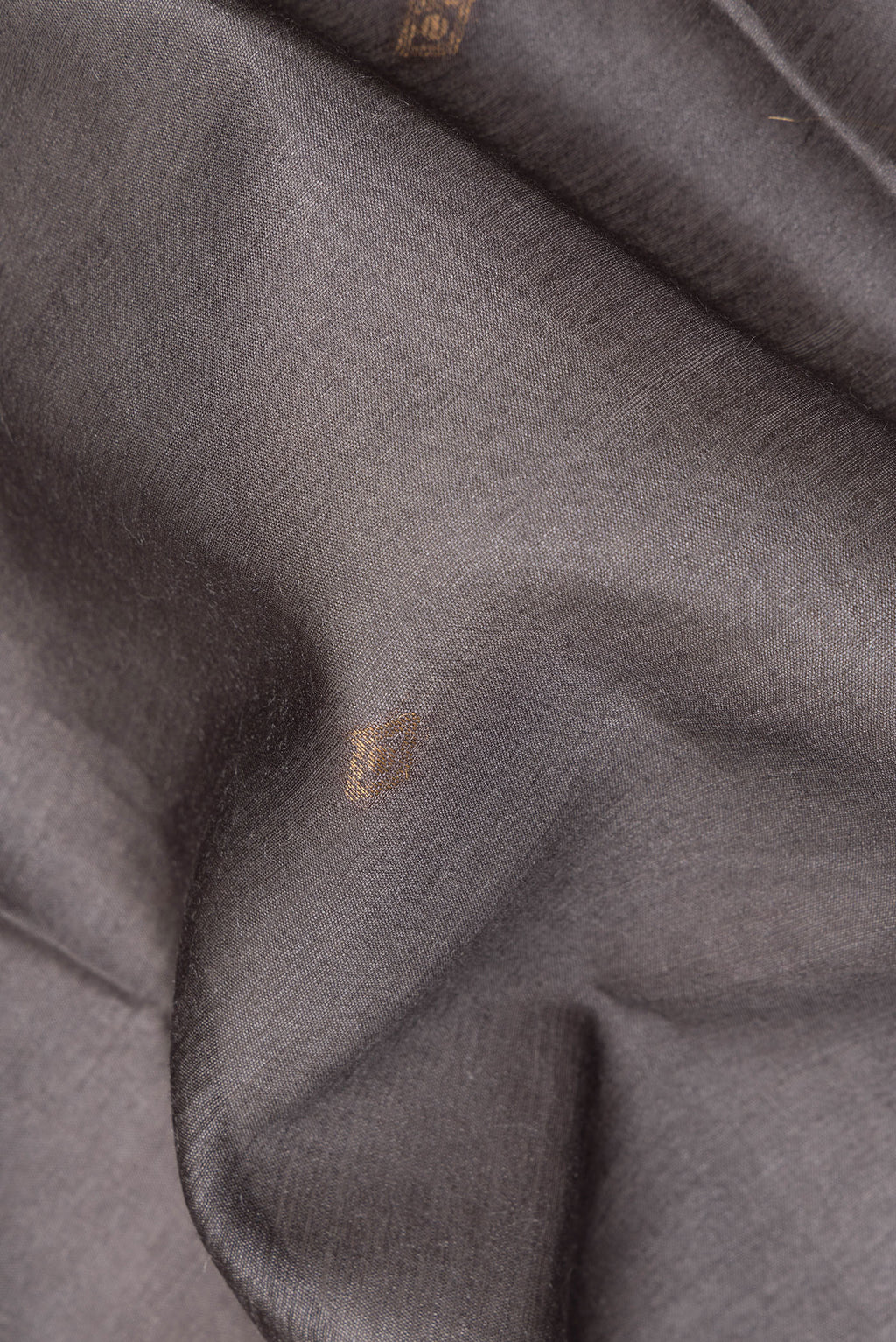 Close up of Grey Tussar Saree with Thread Butta on the body and Ikat Border.  displaying folds