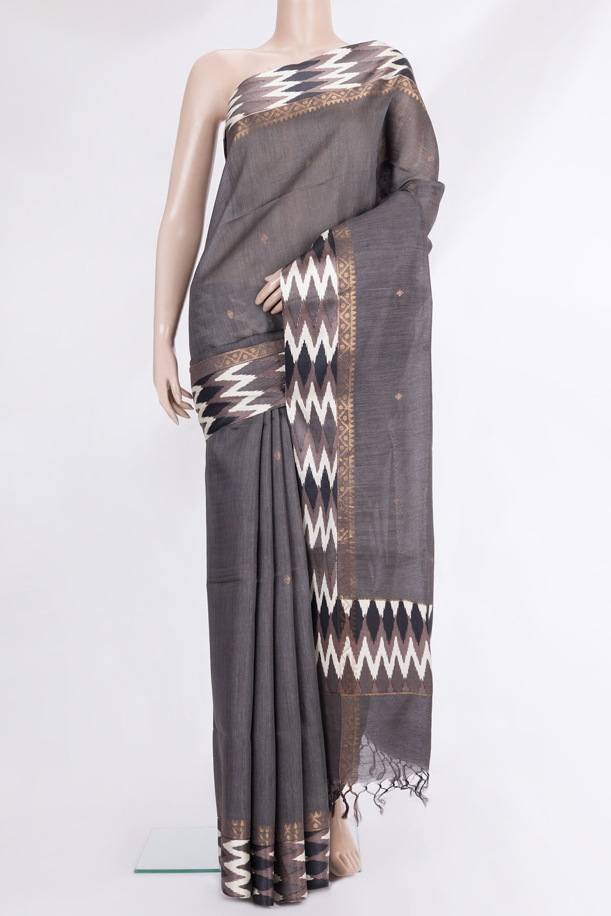 Grey Tussar Saree with Thread Butta on the body and Ikat Border.  displayed on a mannequin