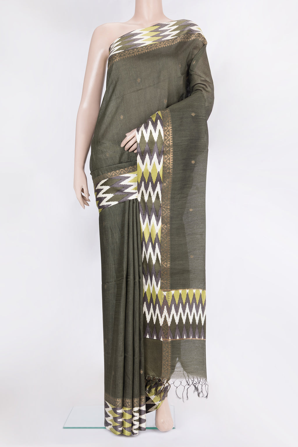 Mehandi Green Tussar Silk Saree with Zari Butta on the body and Ikat Border.  displayed on a mannequin