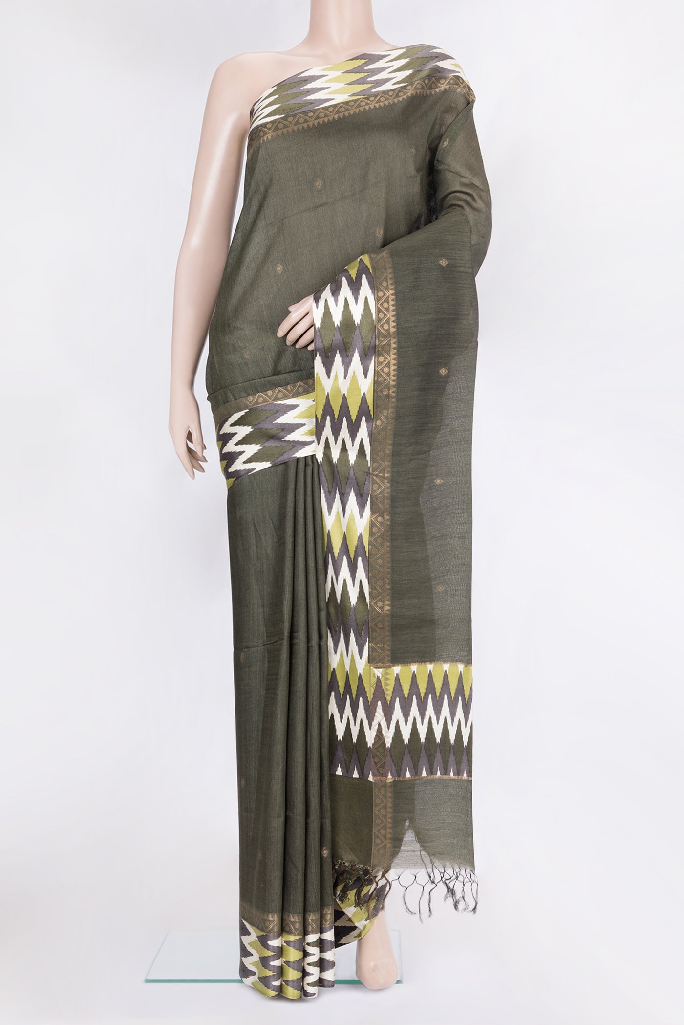 Mehandi Green Tussar Silk Saree with Zari Butta on the body and Ikat Border.  displayed on a mannequin