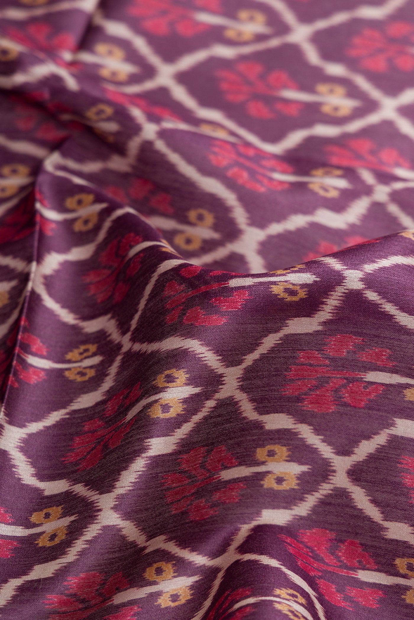 Close up of Purple Dual Tone Tussar Silk Saree with Ikat Print on the body and Zari Border.  displaying folds