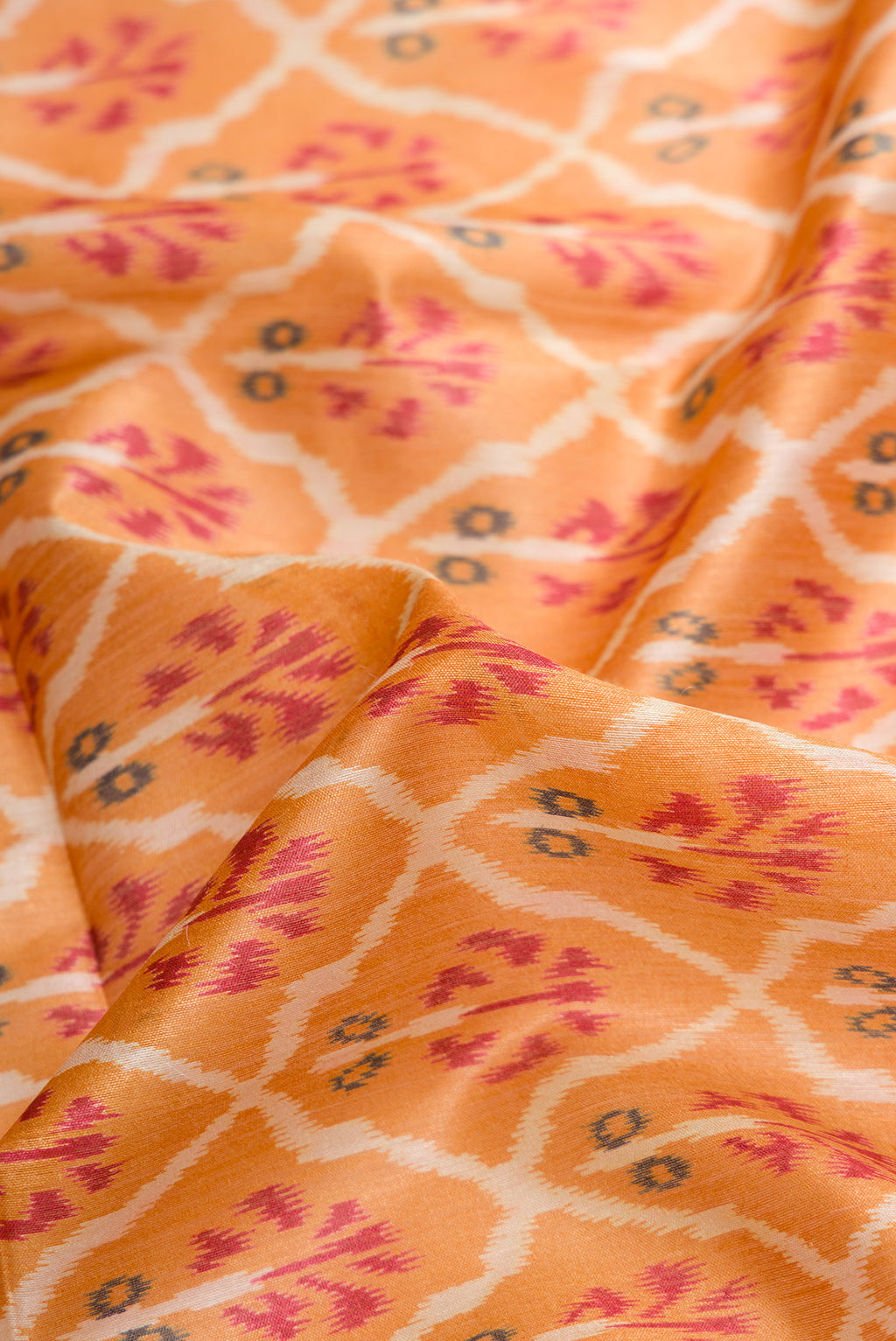 Close up of Mustard Dual Tone Tussar Silk Saree with Ikat Print on the body and Zari Border.  displaying folds