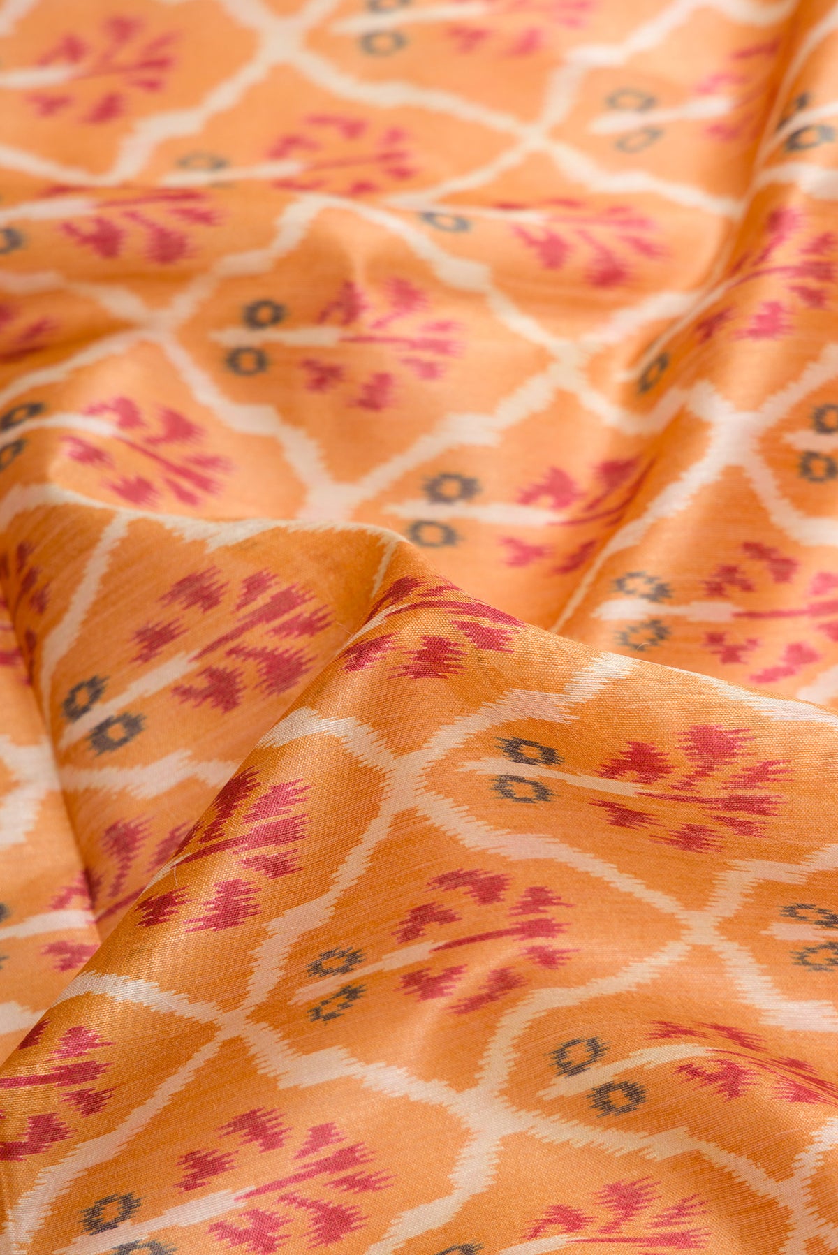 Close up of Mustard Dual Tone Tussar Silk Saree with Ikat Print on the body and Zari Border.  displaying folds