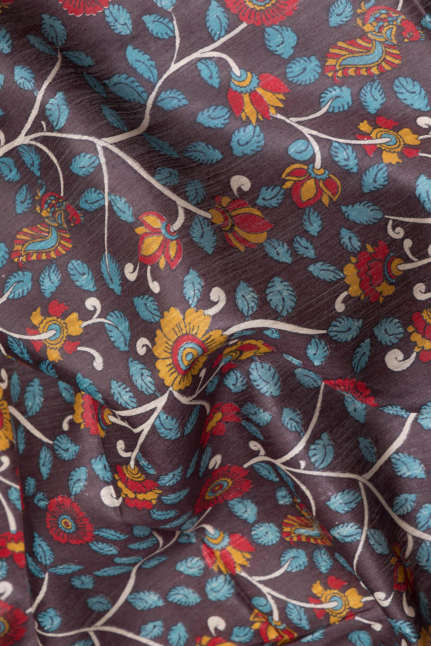 Close up of Brown Tussar Silk Saree with Printed design on the body and Fancy Border.  displaying folds