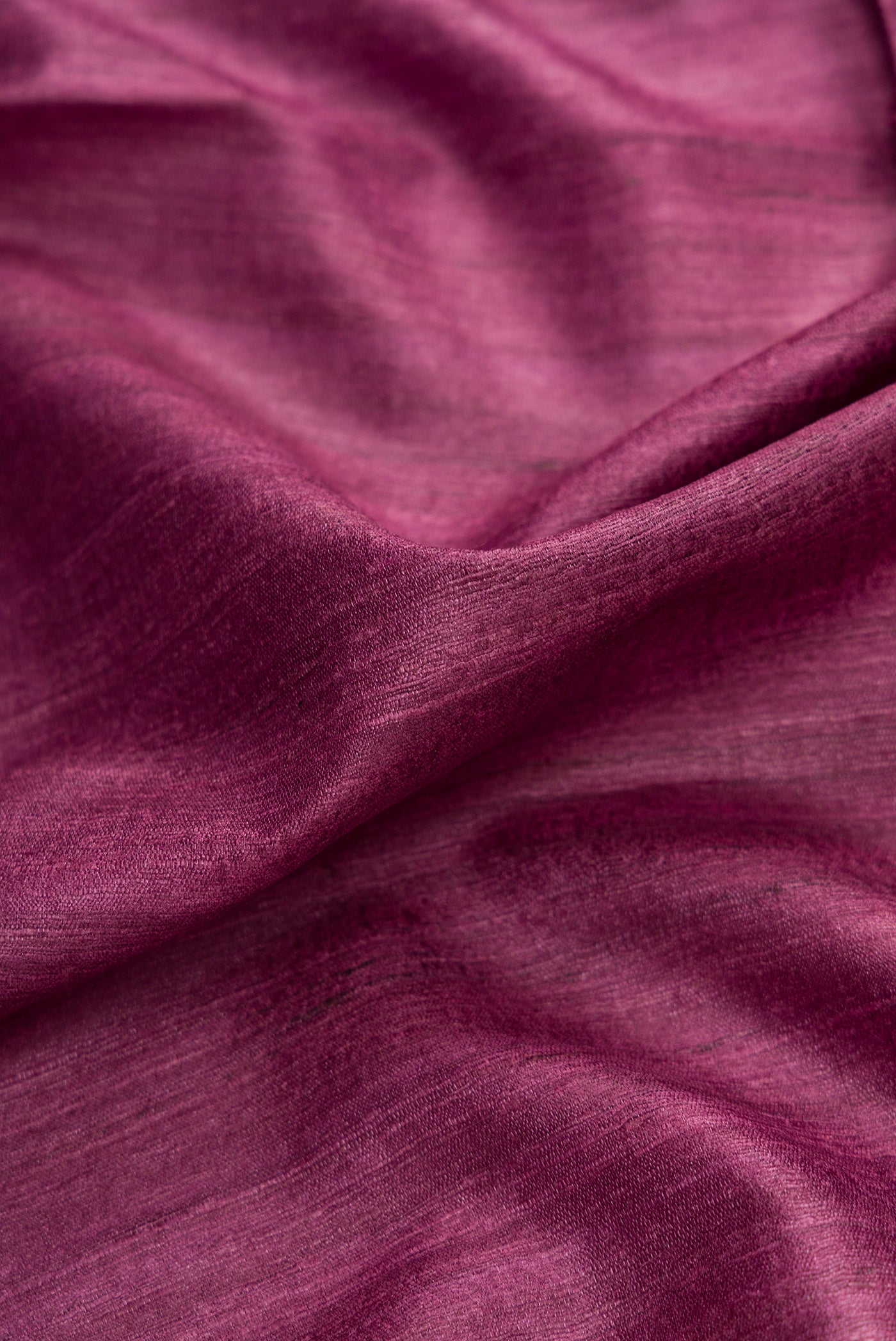 Close up of Purple Dual Tone Tussar Silk Saree with Plain Body and Temple Border.  displaying folds