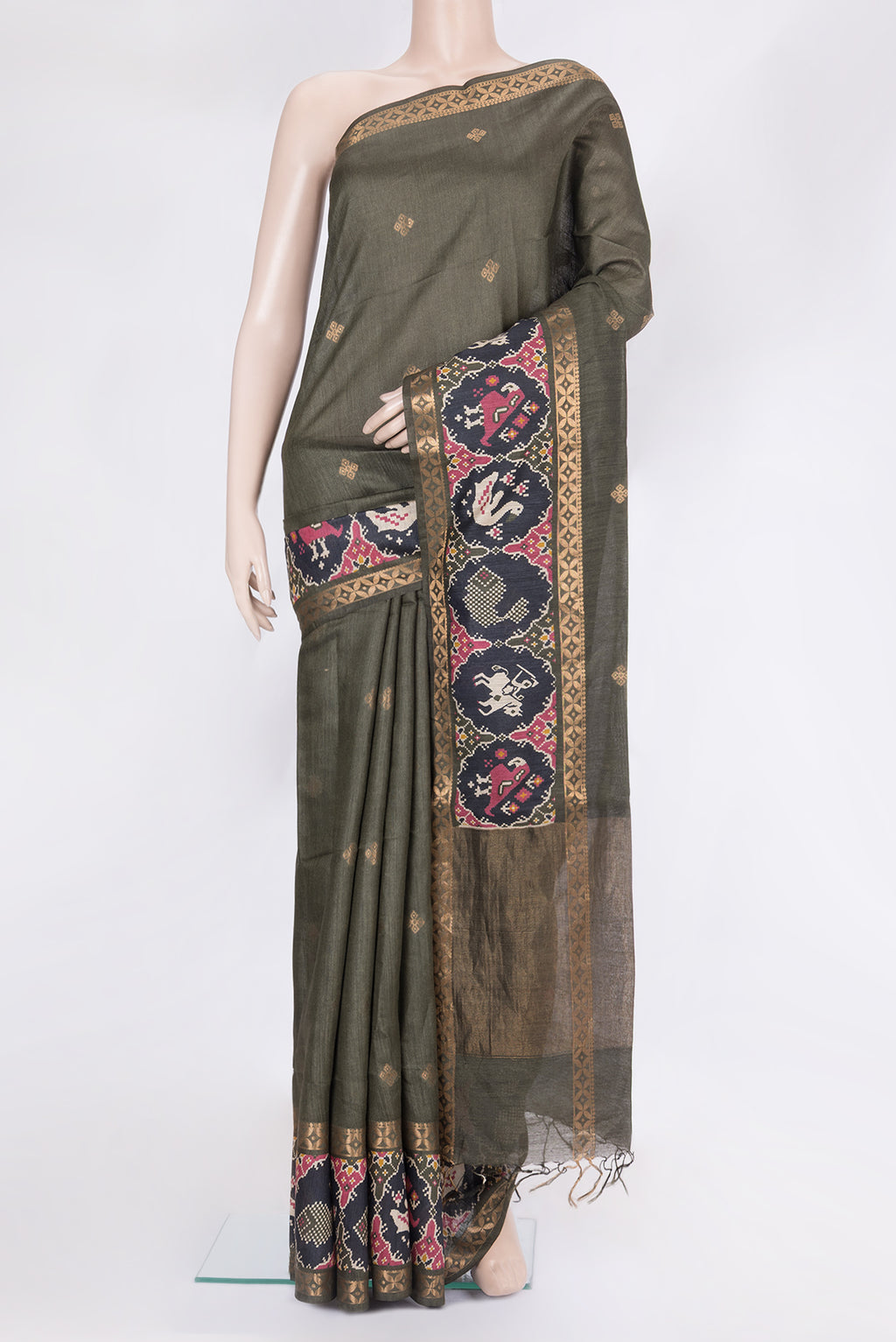 Green Tussar Silk Saree with Zari Butta on the body and Zari Border.  displayed on a mannequin