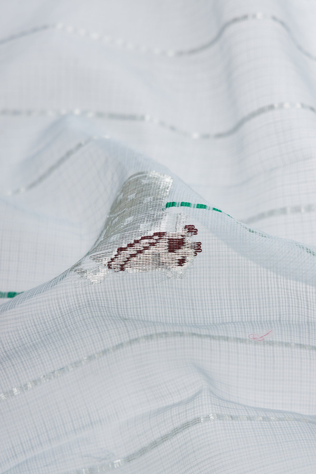 Close up of Grey Dual Tone Kota Silk Saree with Checked design on the body and Zari Border.  displaying folds