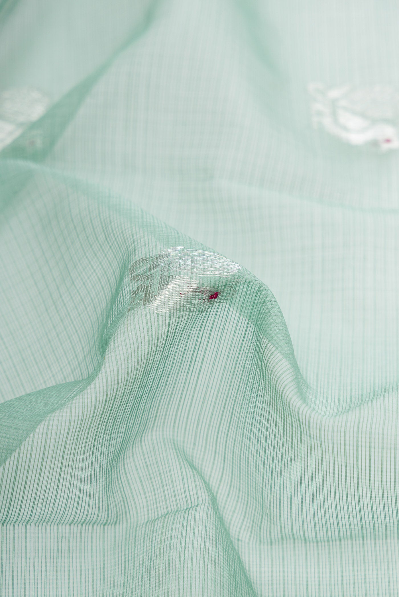 Close up of Sea Green Dual Tone Kota Silk Saree with Zari Butta on the body and Zari Border.  displaying folds
