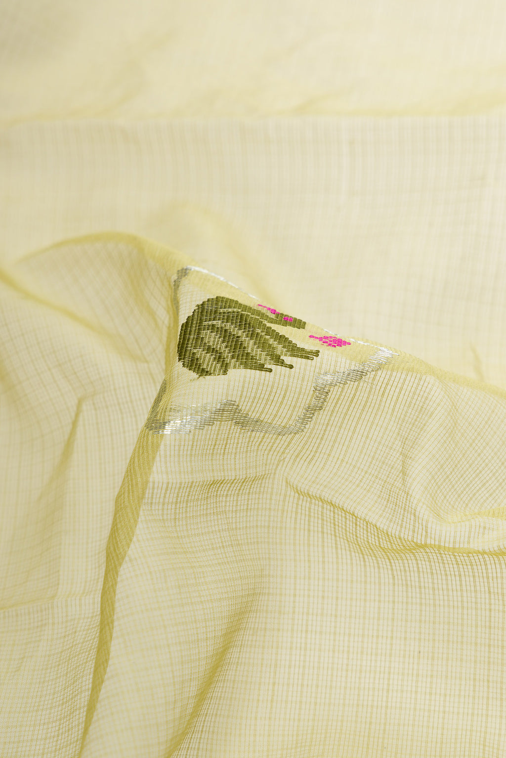 Close up of Pista Green Dual Tone Kota Silk Saree with Zari And Thread Butta on the body and Zari Border.  displaying folds
