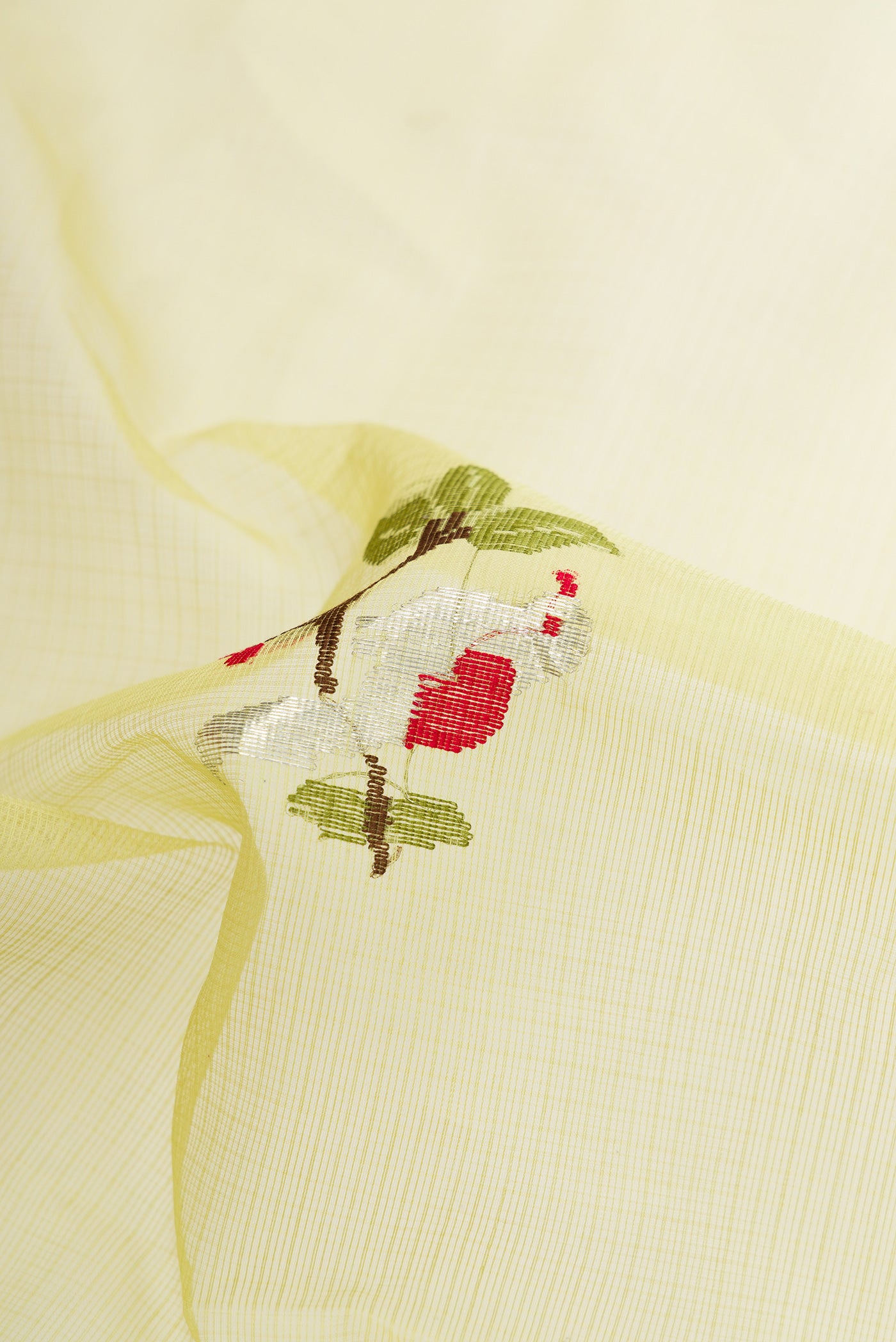 Close up of Pista Green Dual Tone Kota Silk Saree with Zari And Thread Butta on the body and Zari Border.  displaying folds