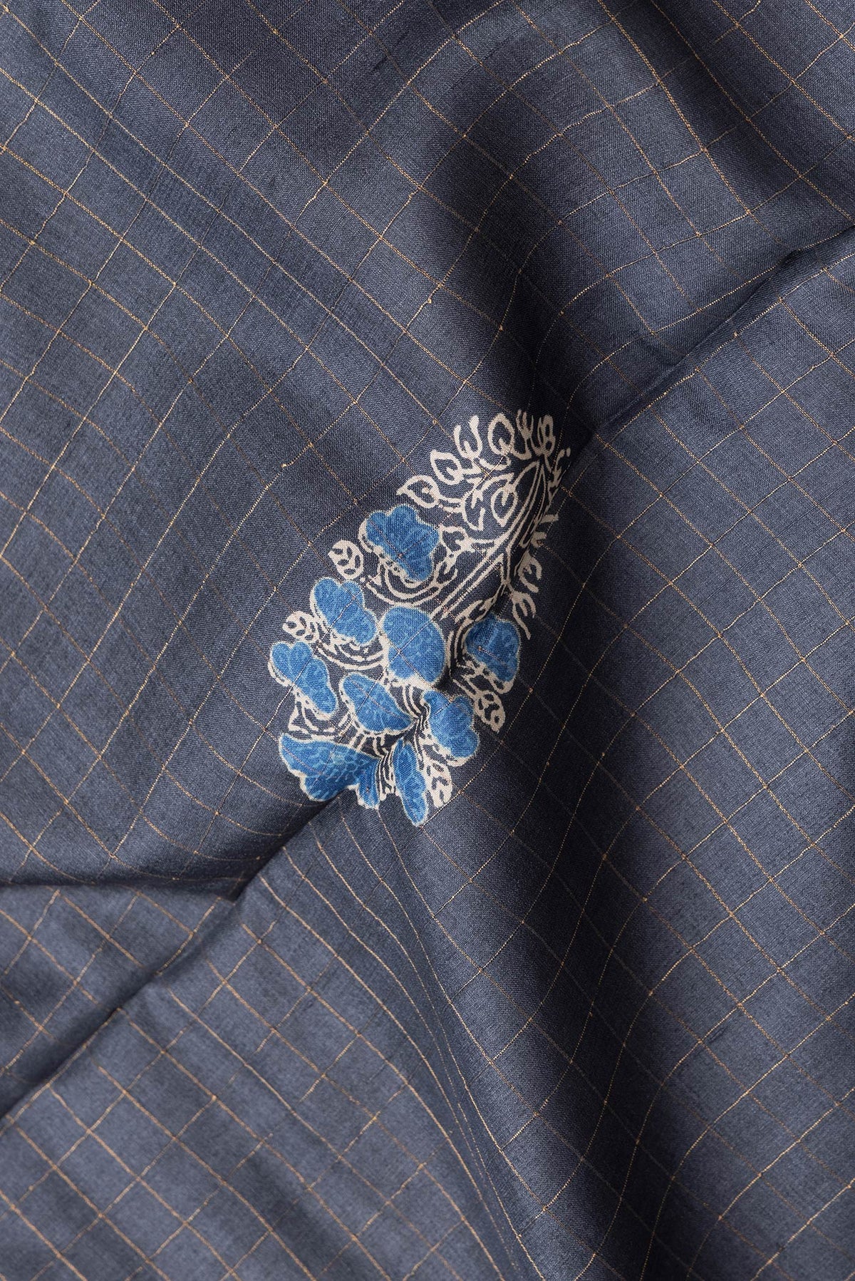 Close up of Grey Dual Tone Tussar Silk Saree with Checked design on the body and Printed Border.  displaying folds