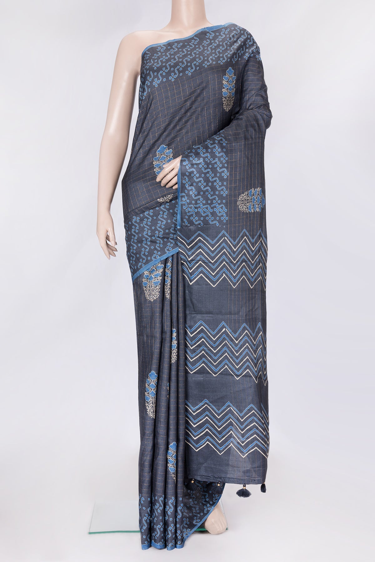 Grey Dual Tone Tussar Silk Saree with Checked design on the body and Printed Border.  displayed on a mannequin