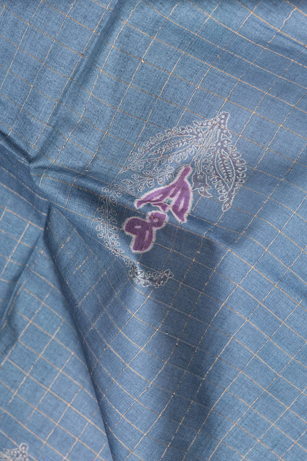 Close up of Blue Grey Tussar Silk Saree with Checked design on the body and Fancy Border.  displaying folds