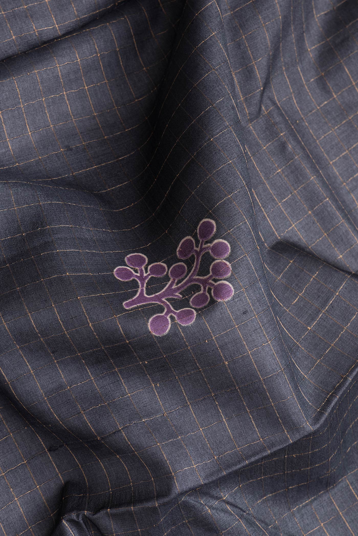 Close up of Grey Dual Tone Tussar Silk Saree with Checked design on the body and Printed Border.  displaying folds