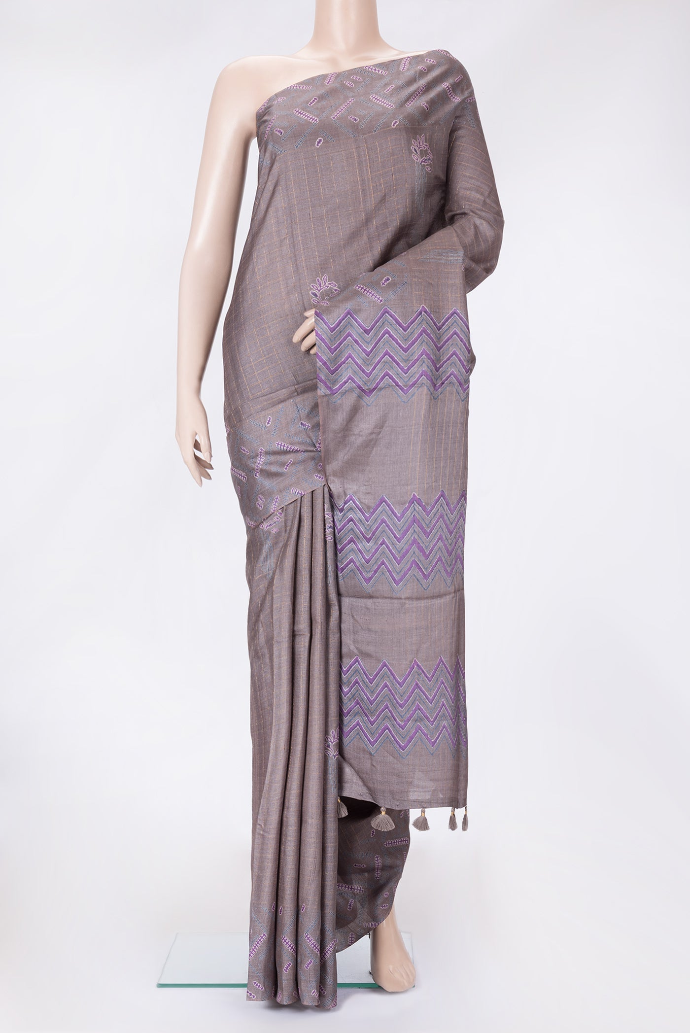 Grey Dual Tone Tussar Silk Saree with Checked design on the body and Printed Border.  displayed on a mannequin