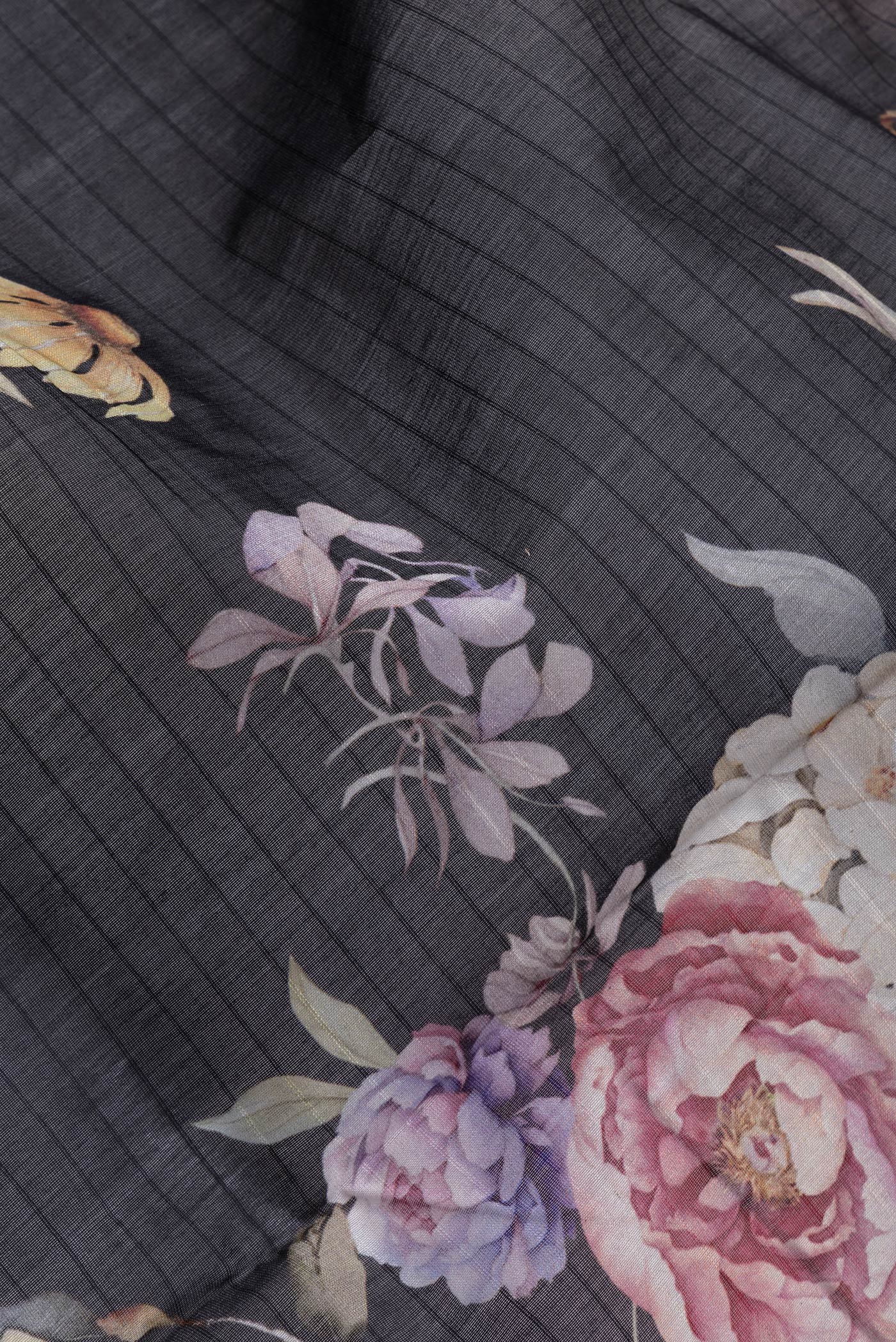 Close up of Black Dual Tone Chanderi Silk Saree with Printed design on the body and Zari And Thread Border.  displaying folds