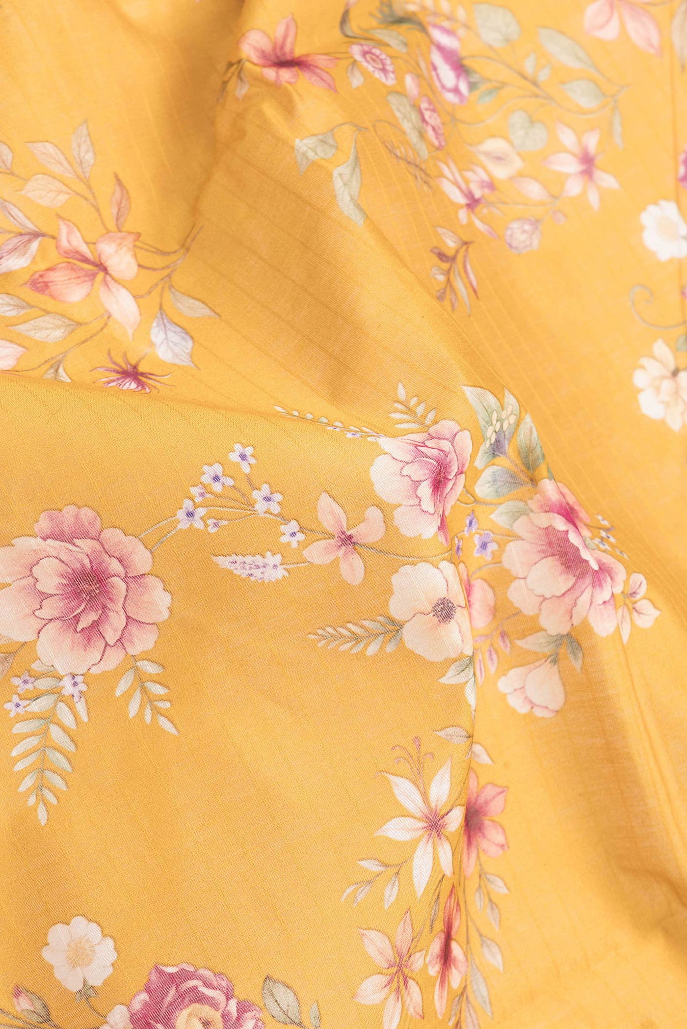 Close up of Mustard Dual Tone Chanderi Silk Saree with Printed design on the body and Zari And Thread Border.  displaying folds
