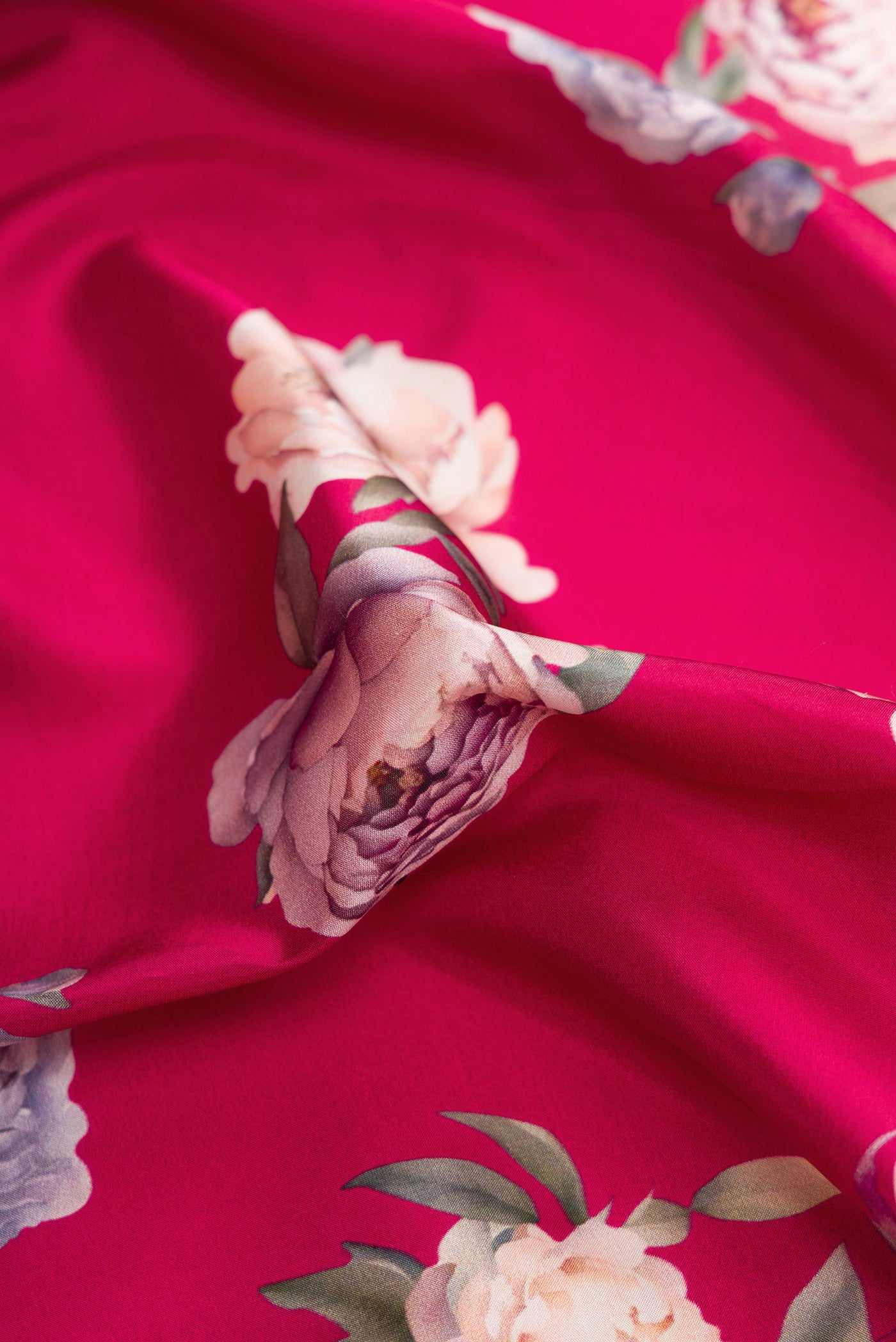 Close up of Dark Mauve Dual Tone Kanchipuram Silk Saree with Printed design on the body and Zari Border.  displaying folds