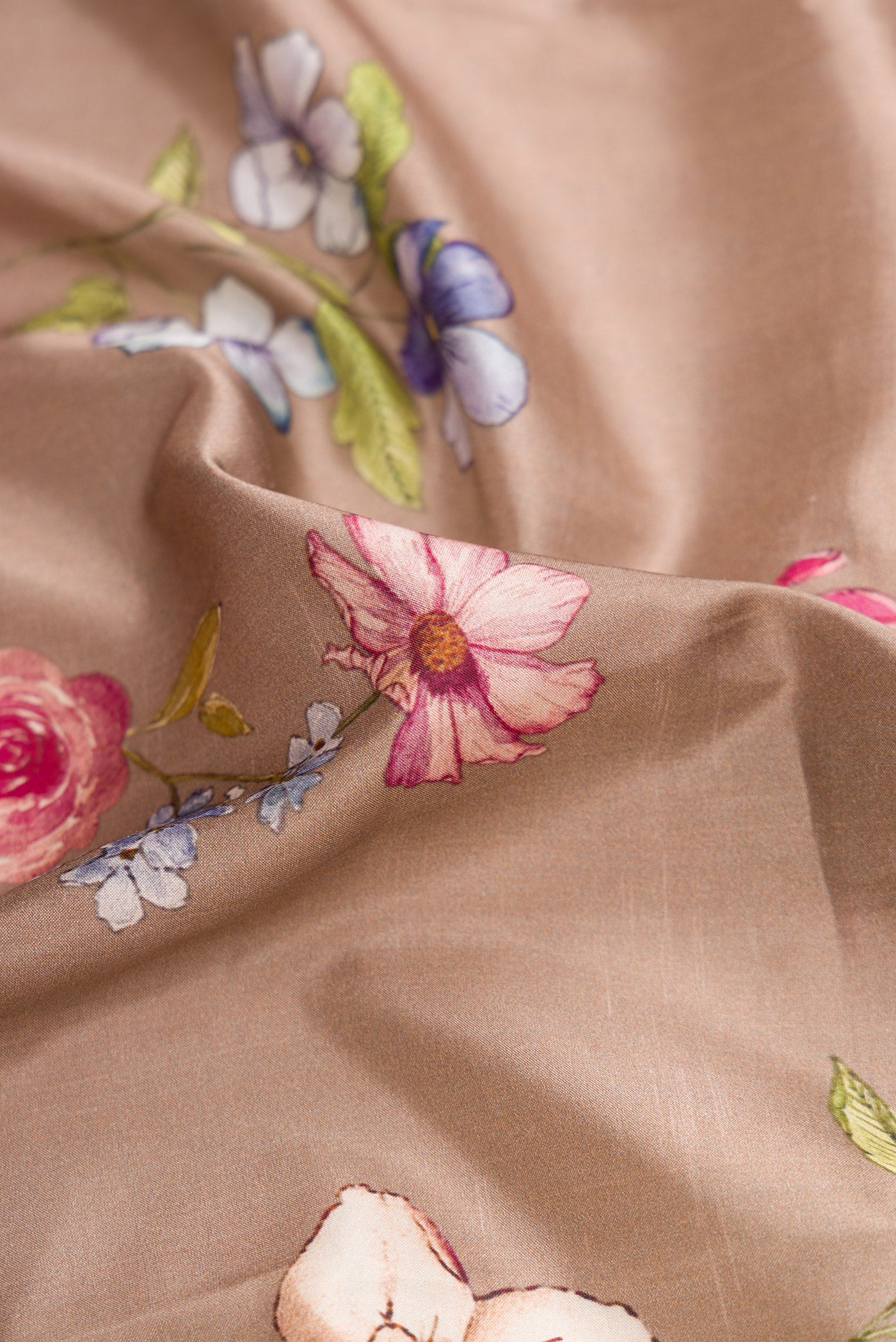 Close up of Brown Dual Tone Kanchipuram Silk Saree with Printed design on the body and Zari Border.  displaying folds