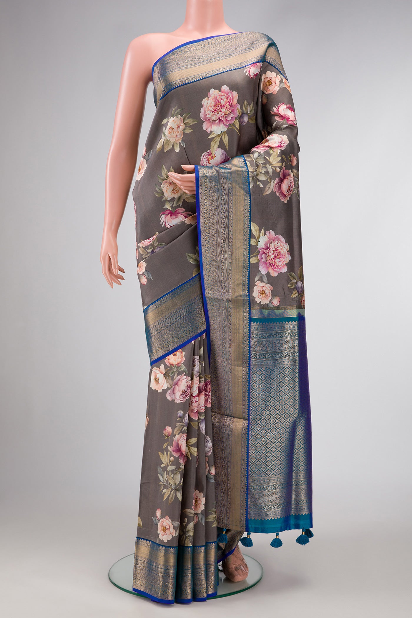 Grey Dual Tone Kanchipuram Silk Saree with Printed design on the body and Zari Border.  displayed on a mannequin