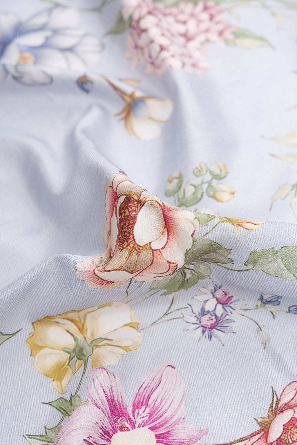 Close up of Light Blue Dual Tone Kanchipuram Silk Saree with Printed design on the body and Zari Border.  displaying folds