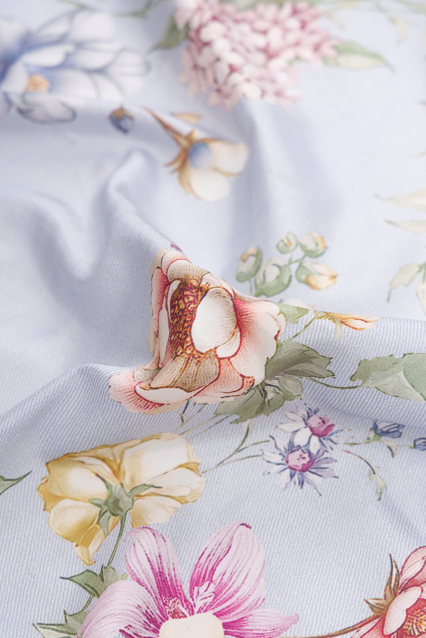 Close up of Light Blue Dual Tone Kanchipuram Silk Saree with Printed design on the body and Zari Border.  displaying folds