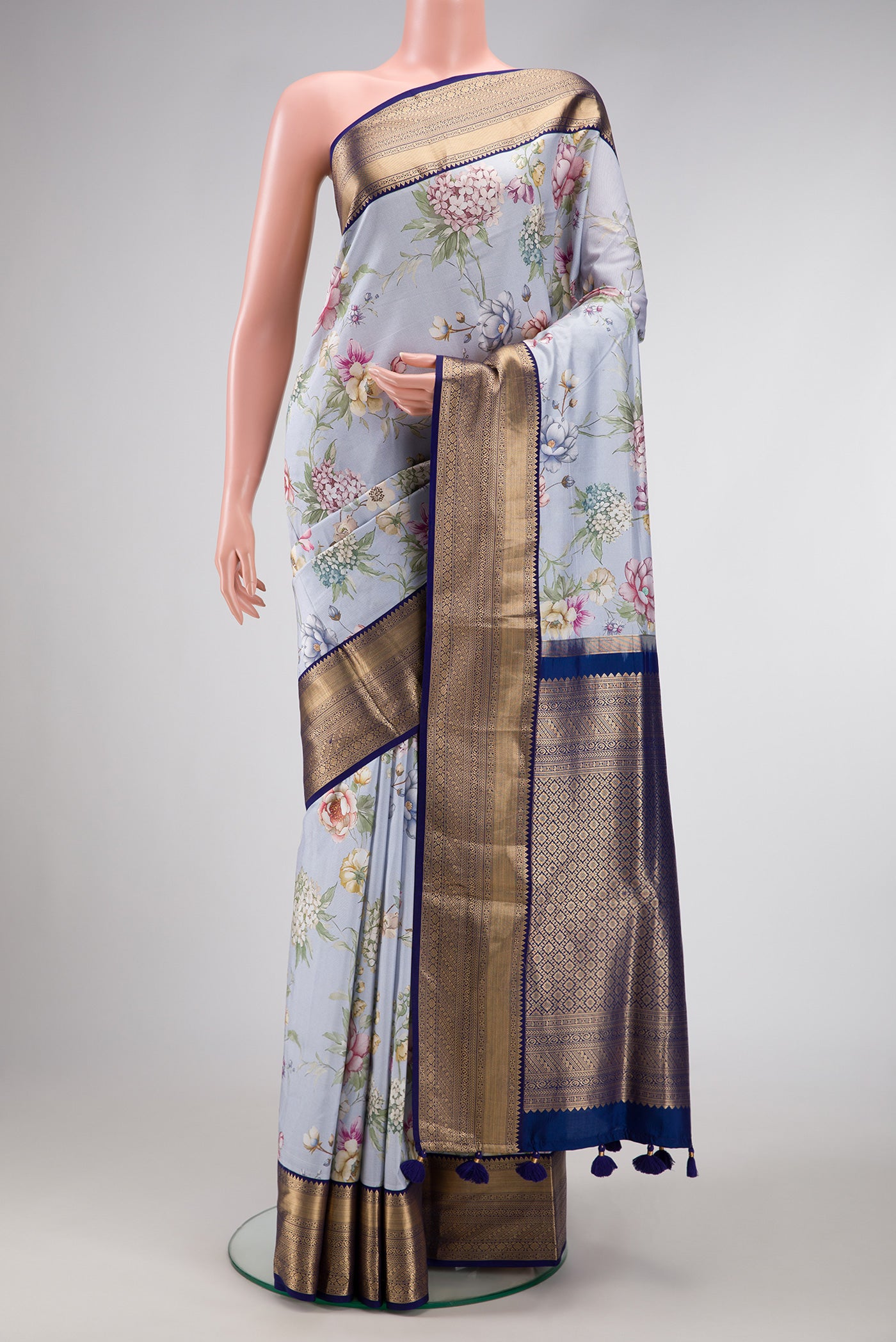 Light Blue Dual Tone Kanchipuram Silk Saree with Printed design on the body and Zari Border.  displayed on a mannequin