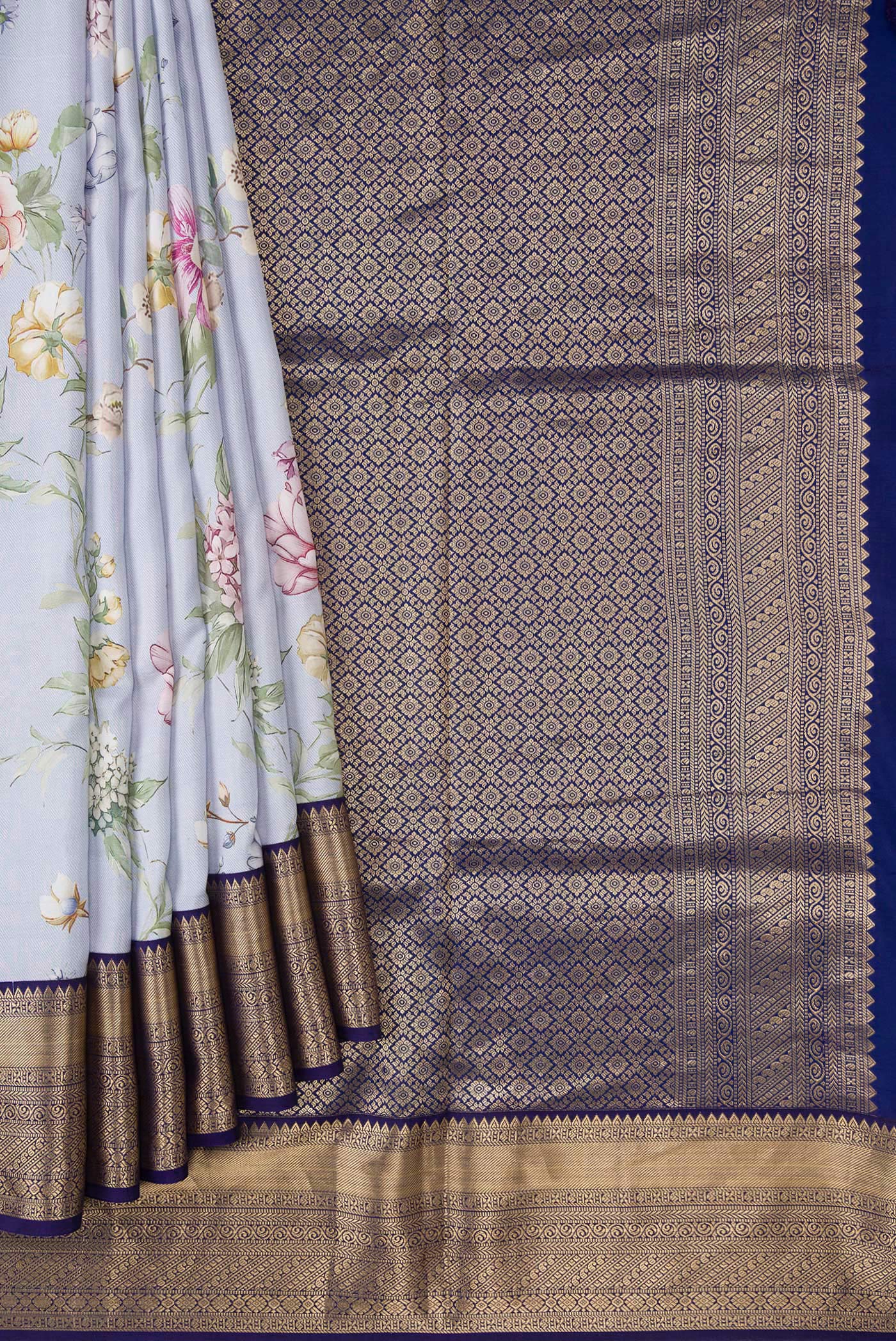 Pleats and pallu of Light Blue Dual Tone Kanchipuram Silk Saree with Printed design on the body and Zari Border. 