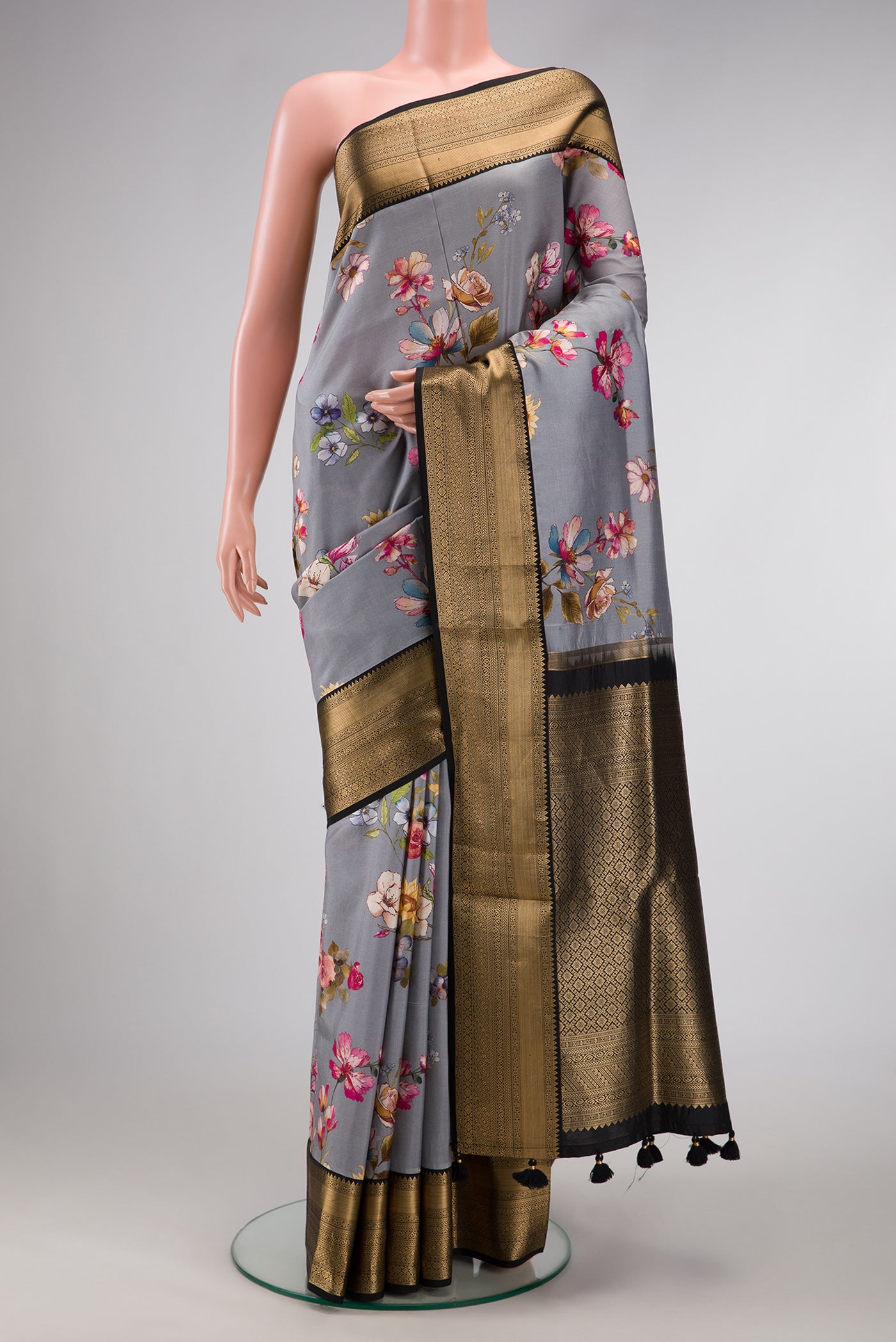 Grey Dual Tone Kanchipuram Silk Saree with Printed design on the body and Zari Border.  displayed on a mannequin
