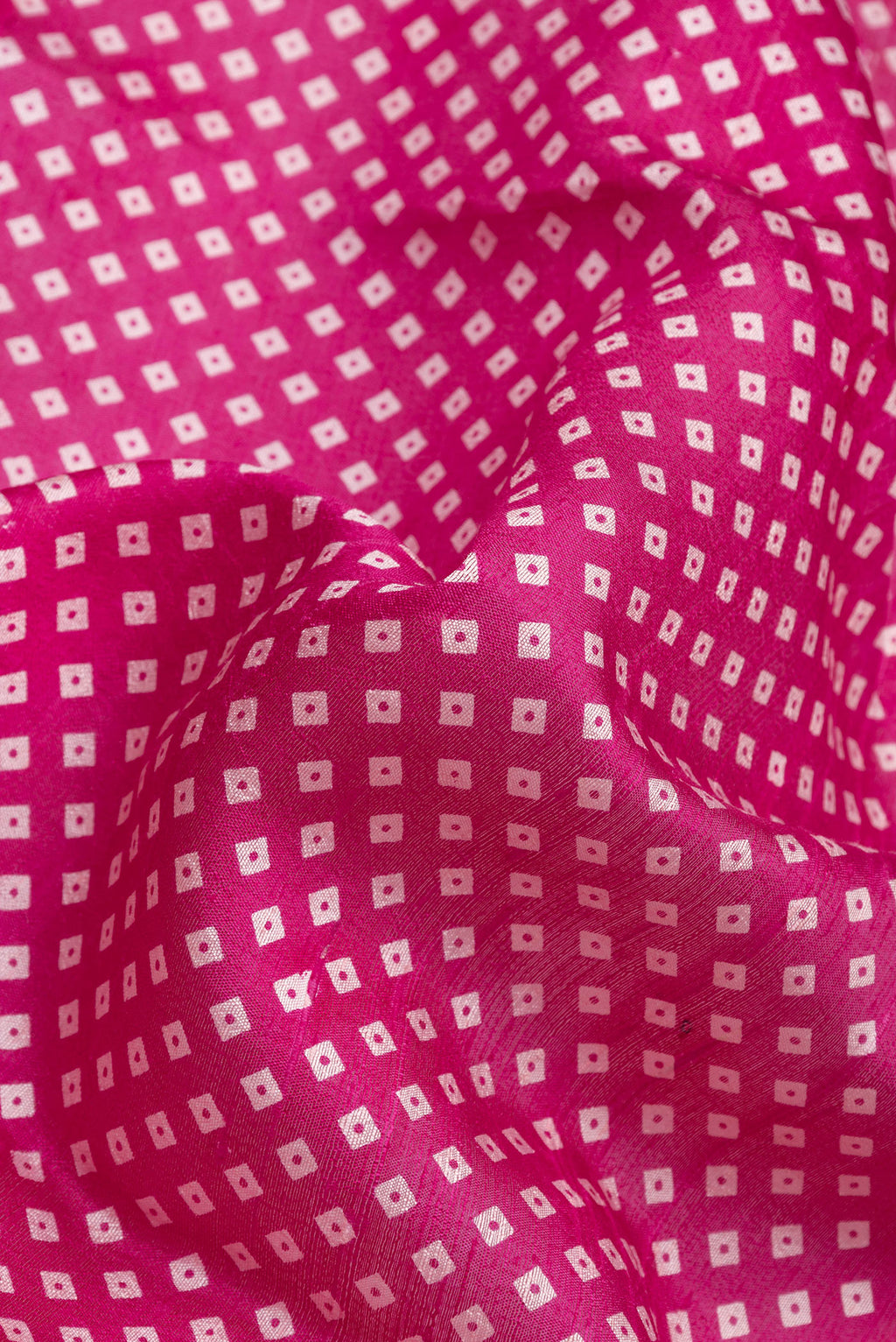 Close up of Pink Dual Tone Tussar Silk Saree with Bandhani Print on the body and Zari Border.  displaying folds