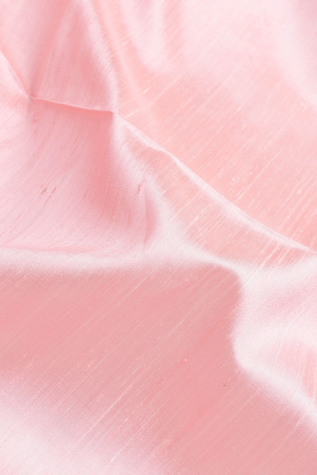 Close up of Pink Dual Tone Raw Silk Saree with Plain Body and Thin Zari Line.  displaying folds