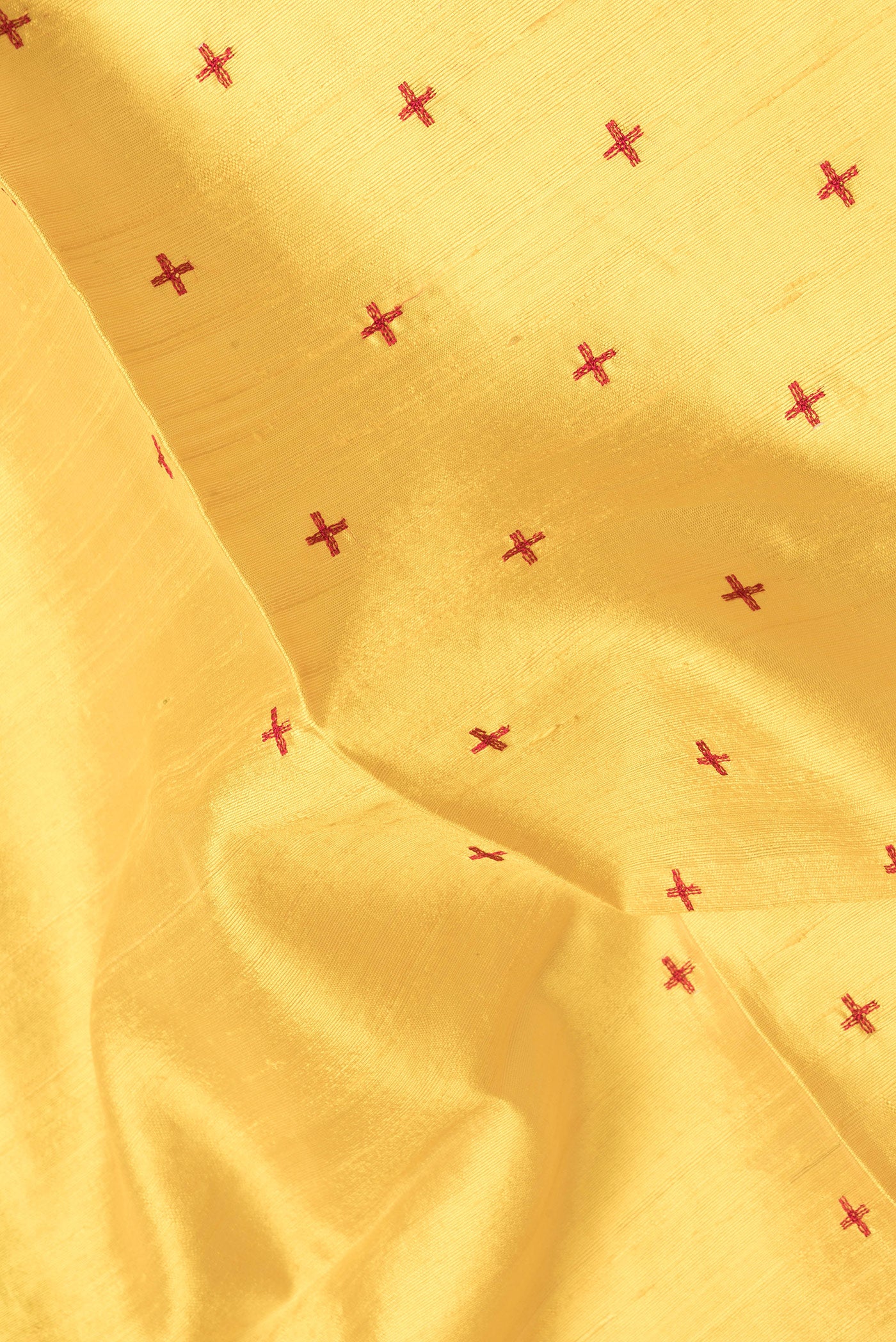 Close up of Yellow Dual Tone Raw Silk Saree with Thread Butta on the body and Thin Zari Line.  displaying folds