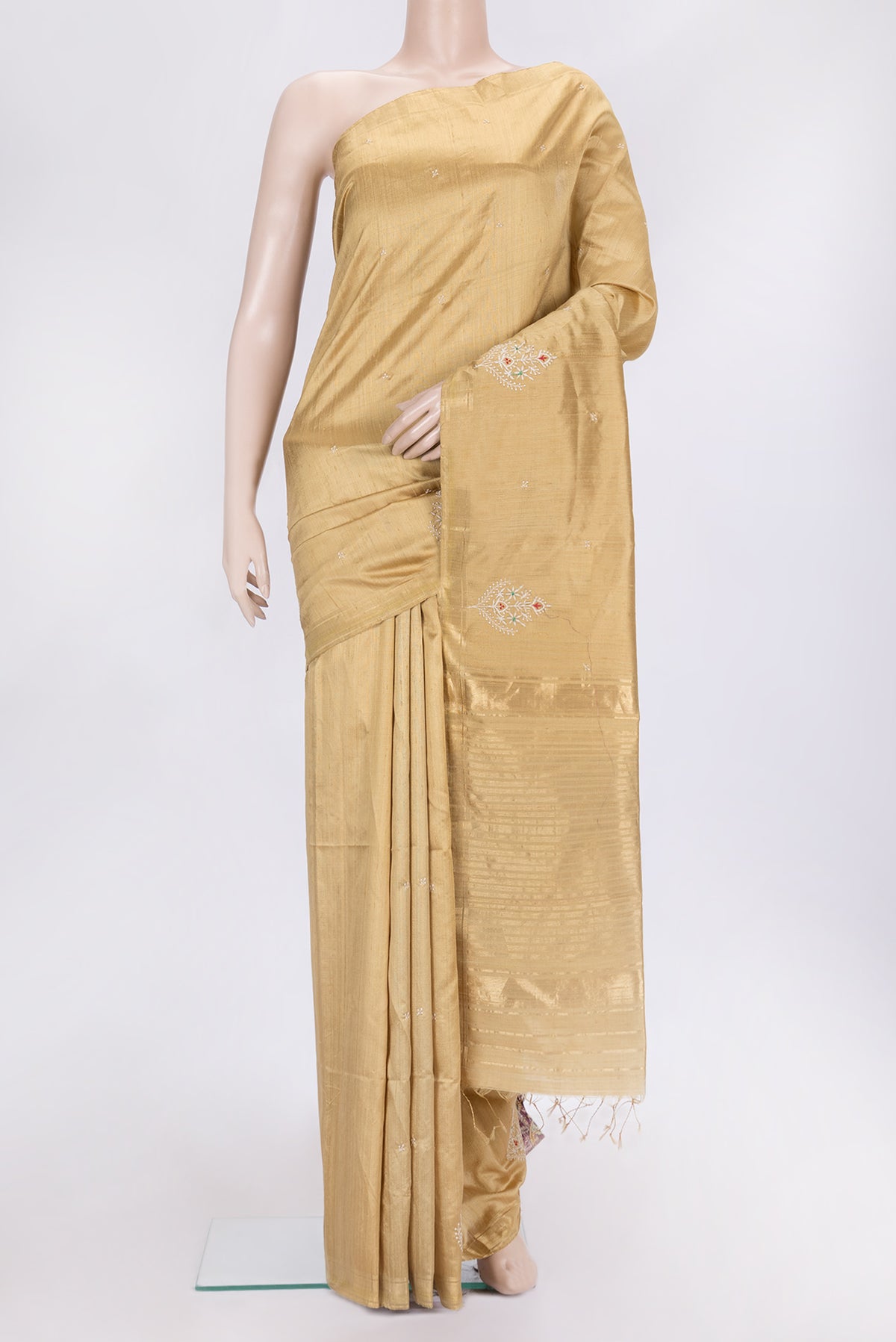 Gold Dual Tone Raw Silk Saree with Embroidery on the body and Zari Border.  displayed on a mannequin