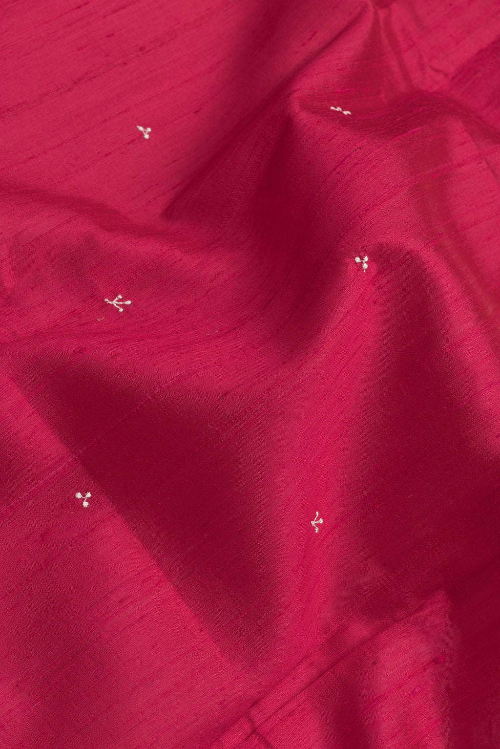 Close up of Dark Pink Dual Tone Raw Silk Saree with Embroidery on the body and Zari Border.  displaying folds