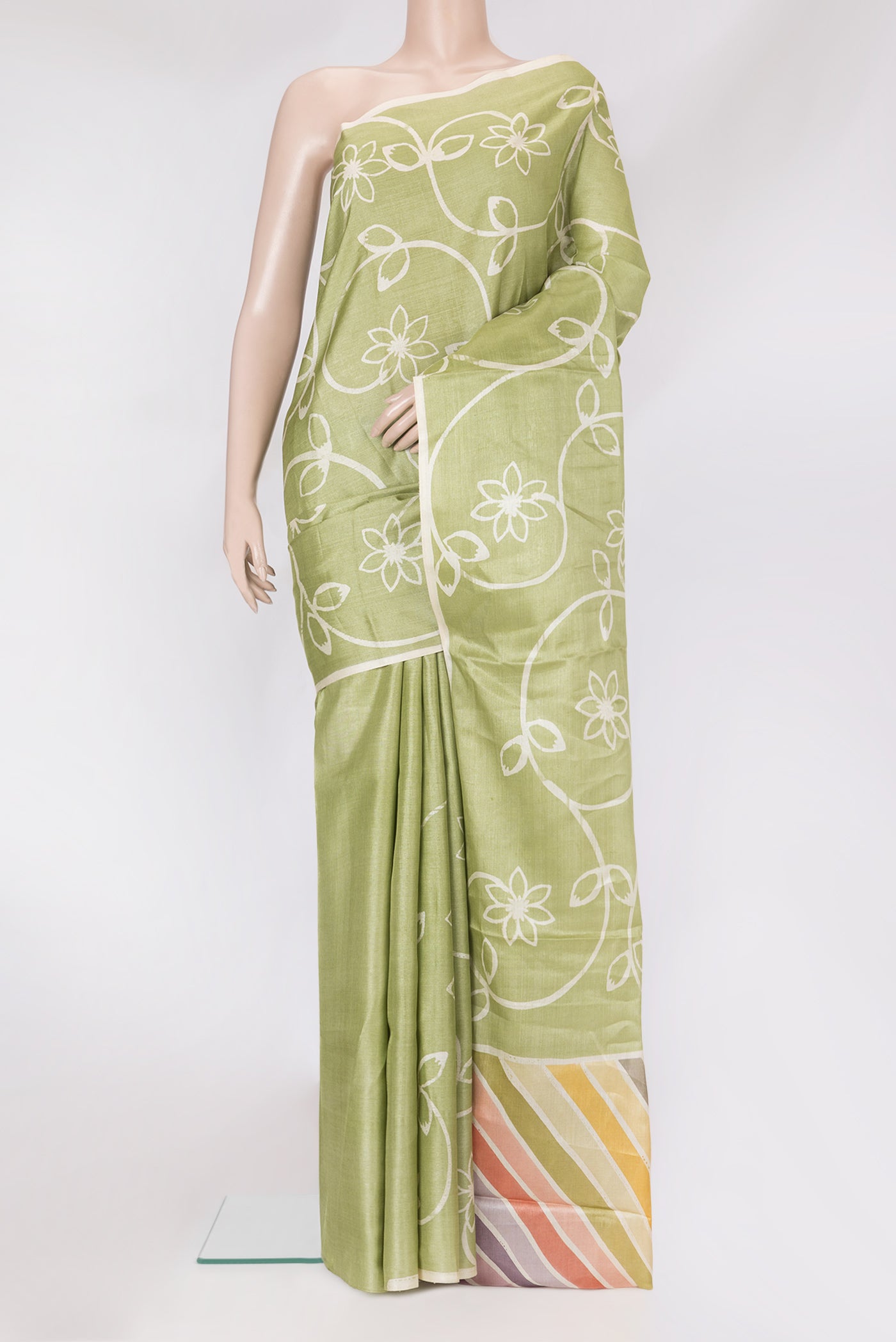 Pista Green Tussar Silk Saree with Printed design on the body and Plain Border.  displayed on a mannequin