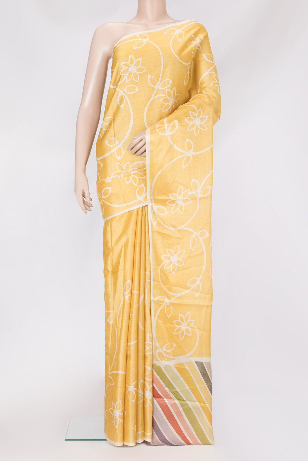 Yellow Tussar Silk Saree with Printed design on the body and Plain Border.  displayed on a mannequin