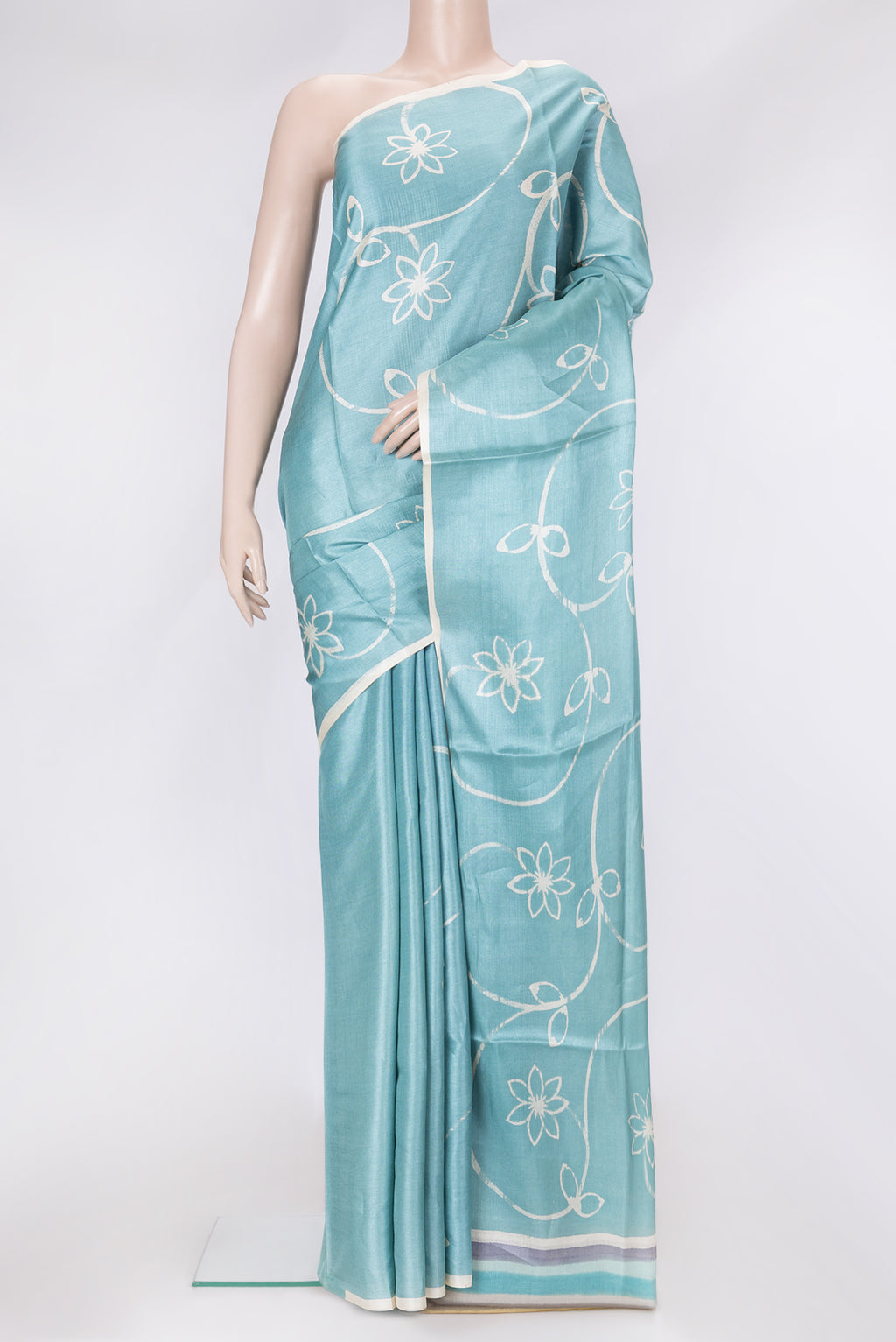 Sky Blue Dual Tone Tussar Silk Saree with Printed design on the body and Plain Border.  displayed on a mannequin