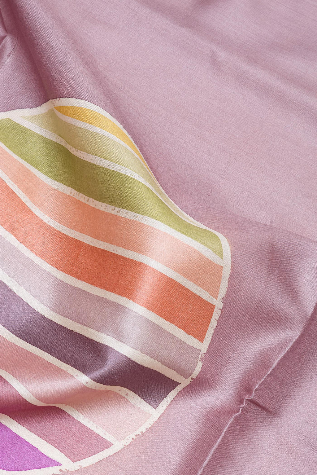 Close up of Lavender Tussar Silk Saree with Printed design on the body and Plain Border.  displaying folds