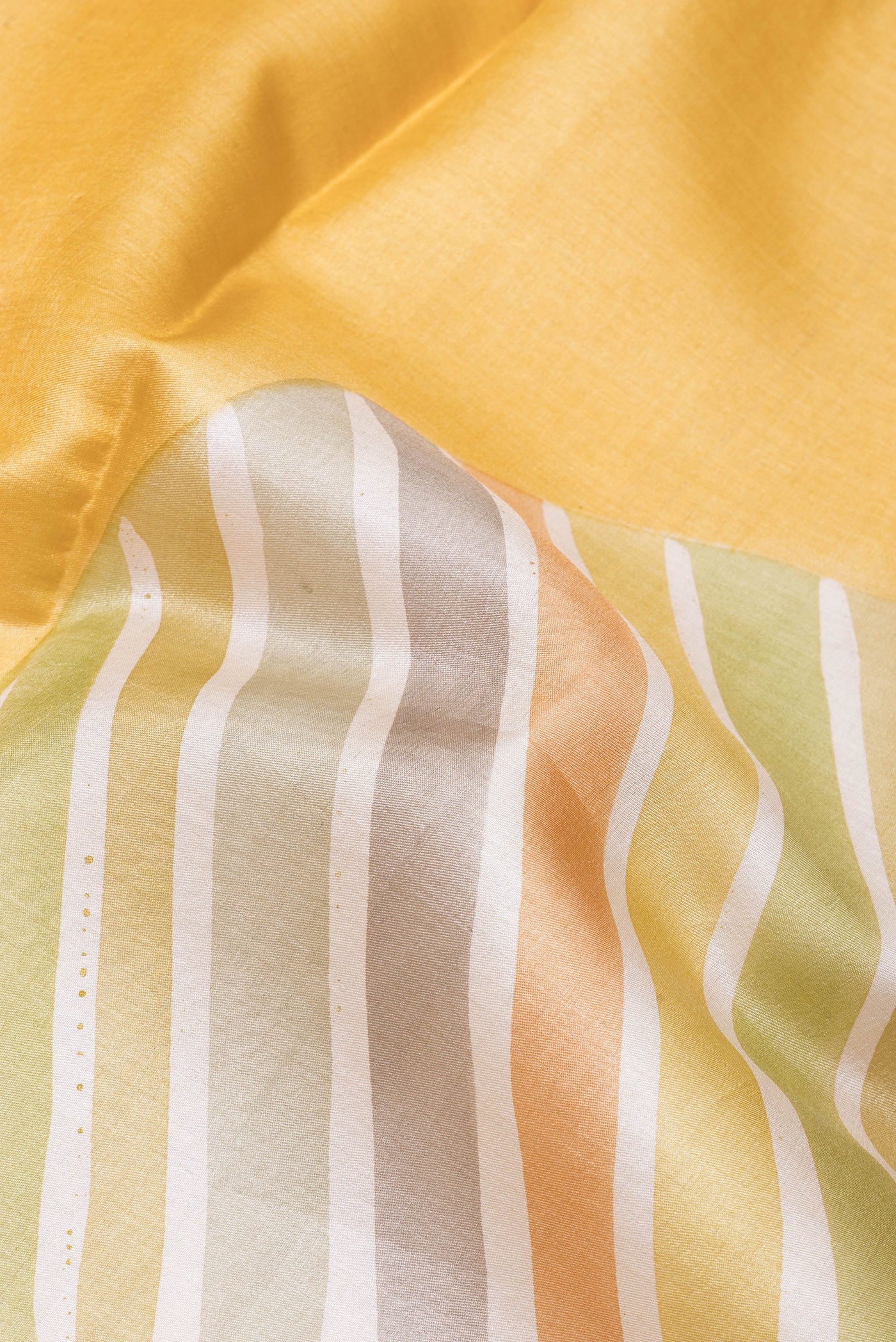 Close up of Sandal Tussar Silk Saree with Printed design on the body and Without Border.  displaying folds