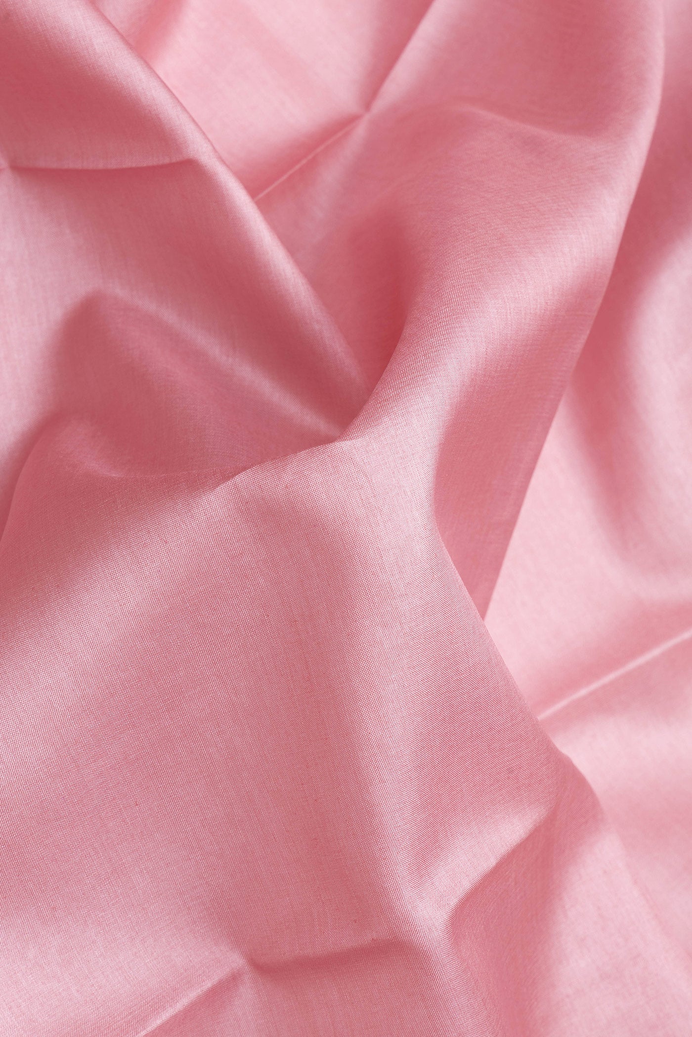 Close up of Rose pink Tussar Silk Saree with Plain Body and Fancy Border.  displaying folds