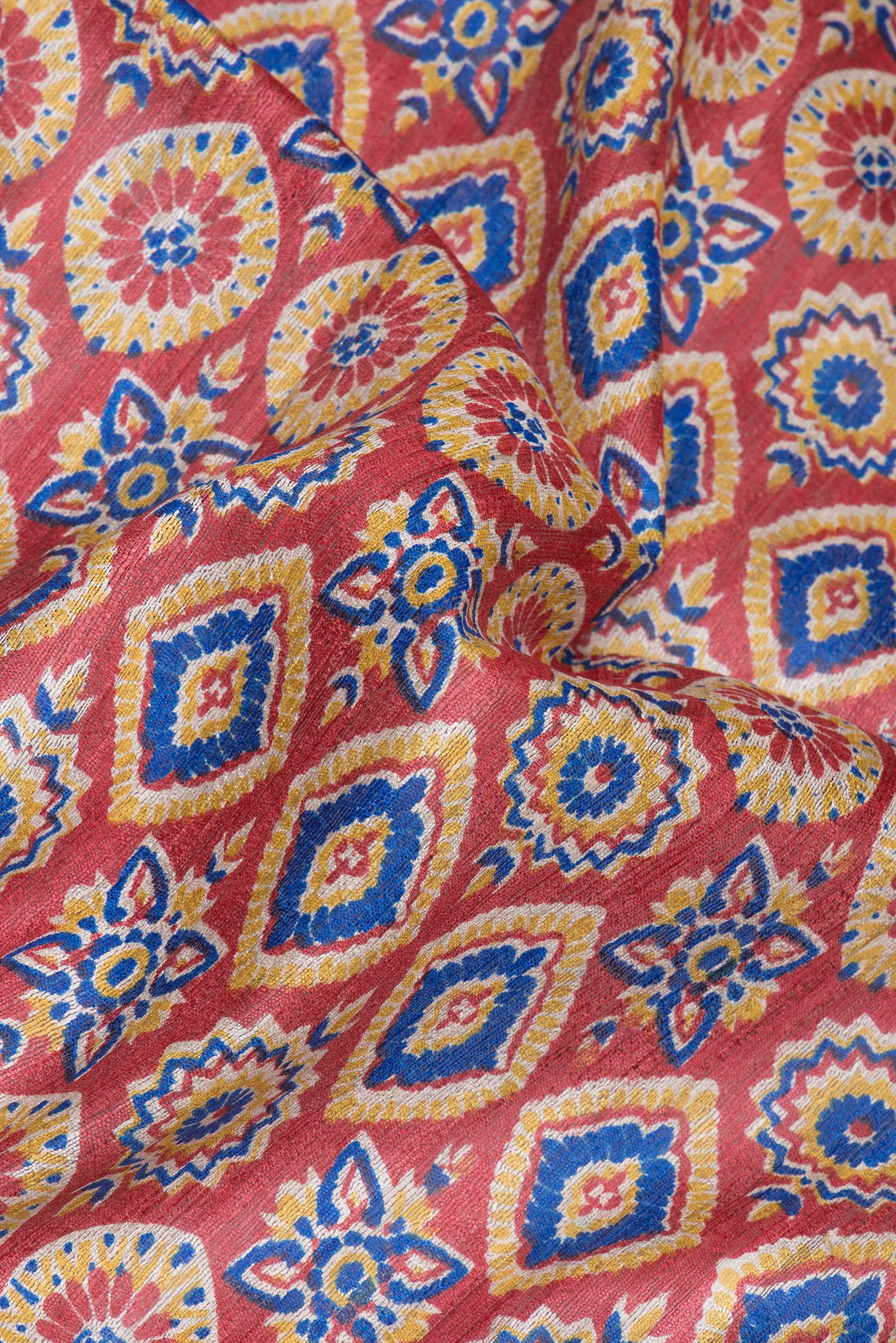 Close up of Maroon Tussar Silk Saree with Printed design on the body and Zari Border.  displaying folds