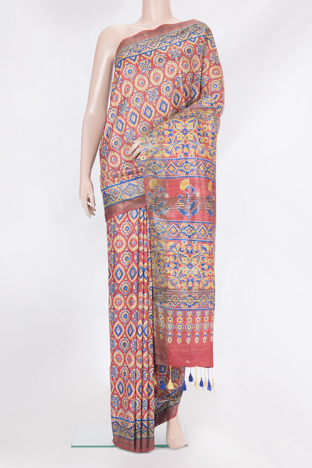 Maroon Tussar Silk Saree with Printed design on the body and Zari Border.  displayed on a mannequin