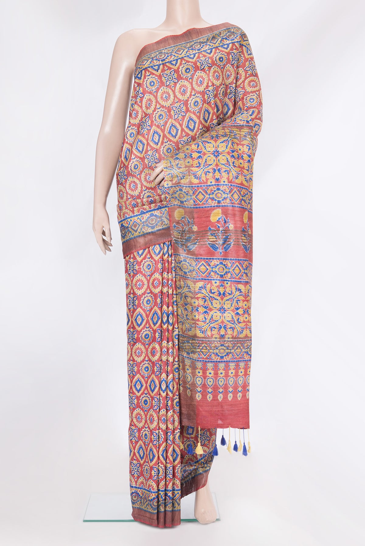 Maroon Tussar Silk Saree with Printed design on the body and Zari Border.  displayed on a mannequin