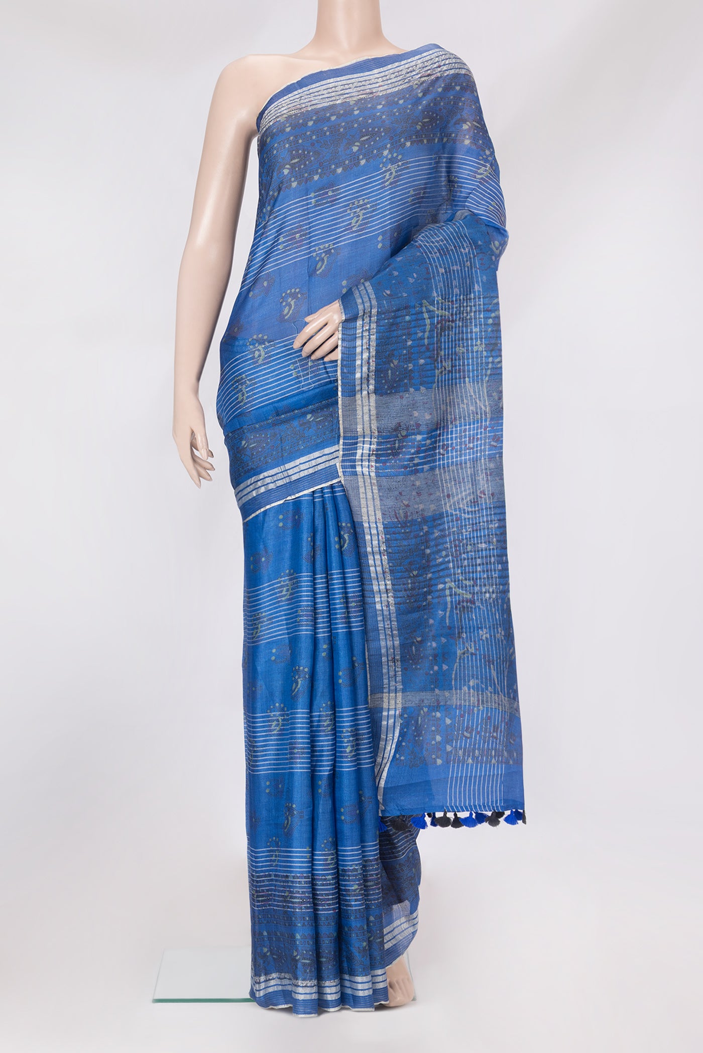 Peacock Blue Tussar Silk Saree with Printed design on the body and Printed Border.  displayed on a mannequin