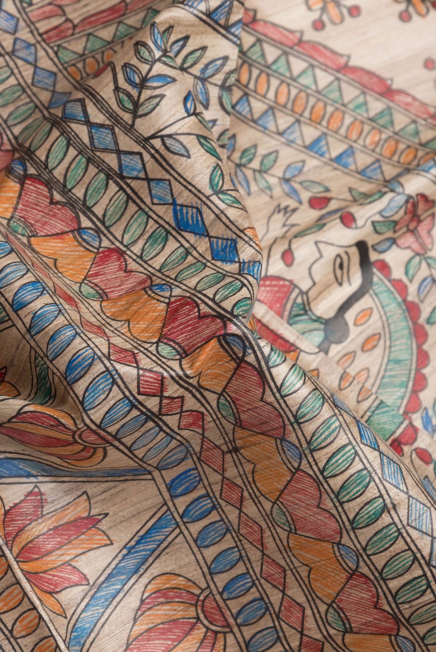 Close up of Beige Dual Tone Tussar Silk Saree with Printed design on the body and Fancy Border.  displaying folds