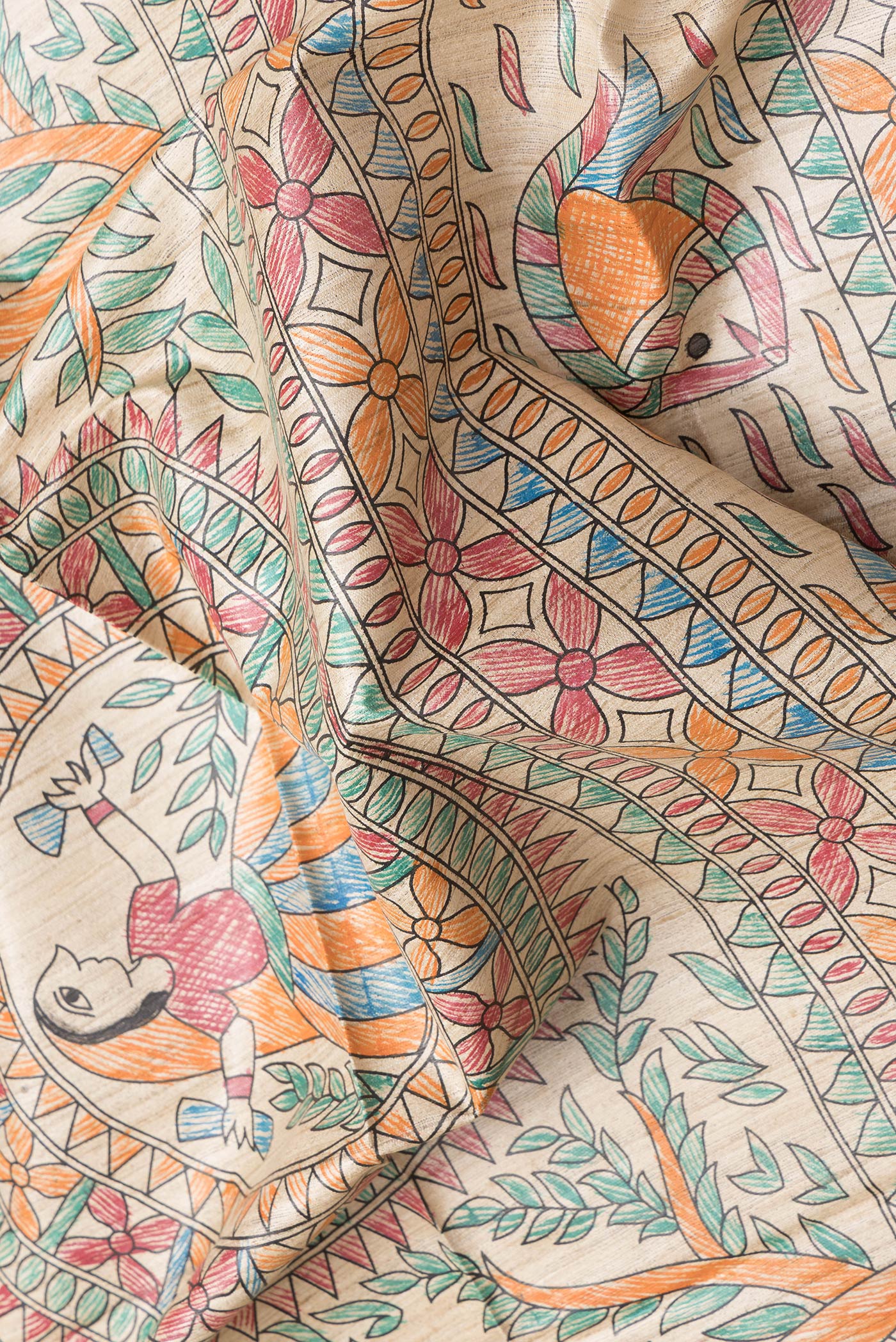 Close up of Beige Dual Tone Tussar Silk Saree with Printed design on the body and Fancy Border.  displaying folds