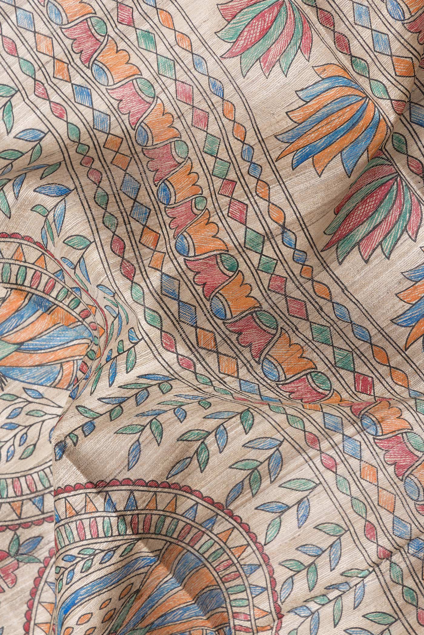 Close up of Beige Dual Tone Tussar Silk Saree with Printed design on the body and Printed Border.  displaying folds