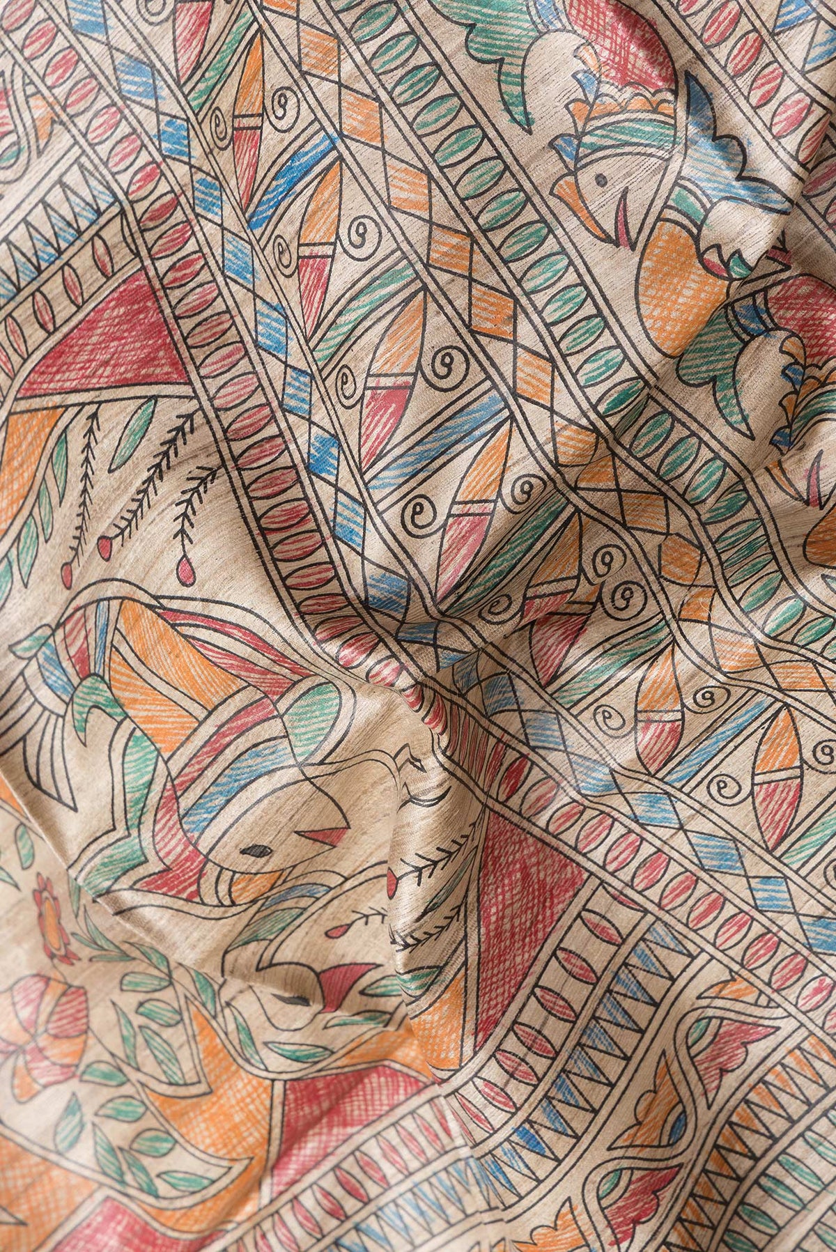 Close up of Beige Dual Tone Tussar Silk Saree with Printed design on the body and Printed Border.  displaying folds